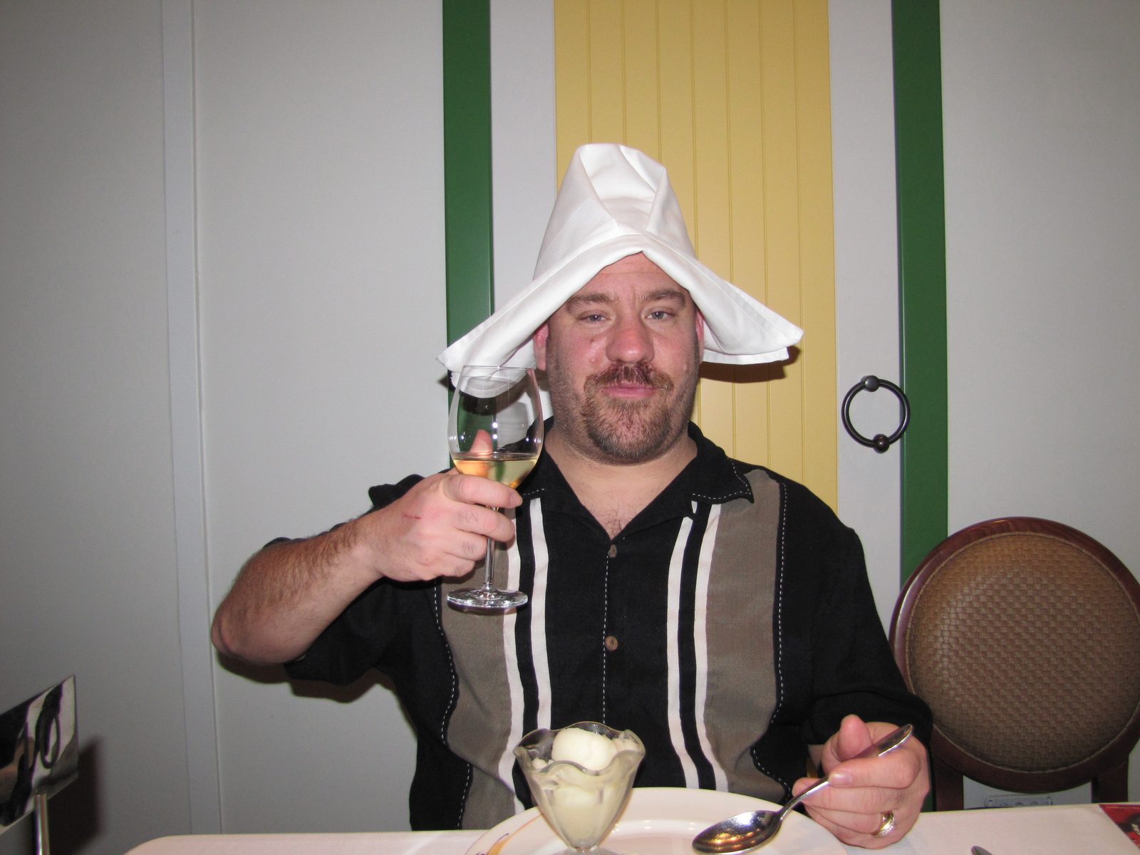 Me raising a toast with a napkin on my head