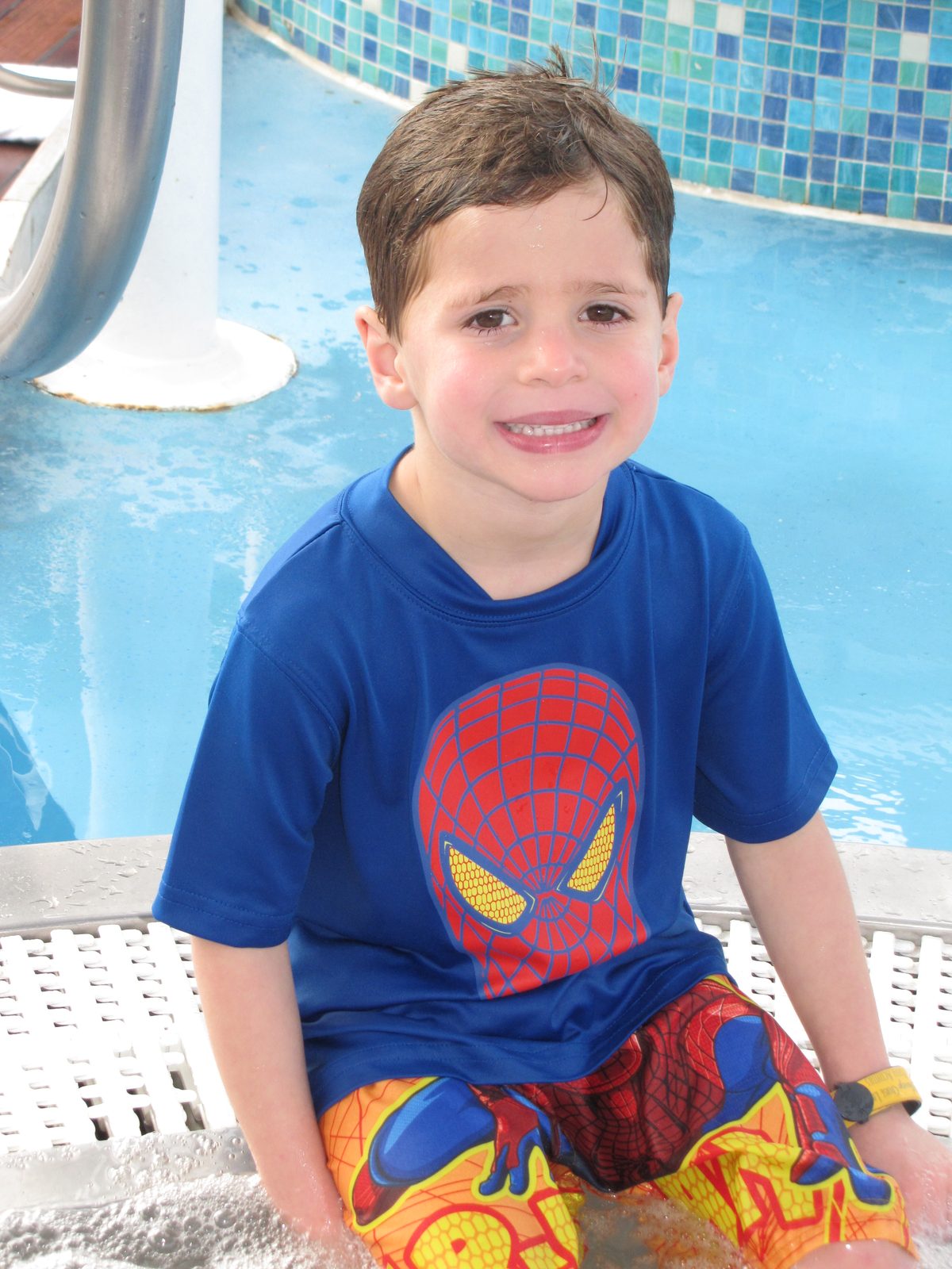 Thomas in his Spider-Man shirt by the pool