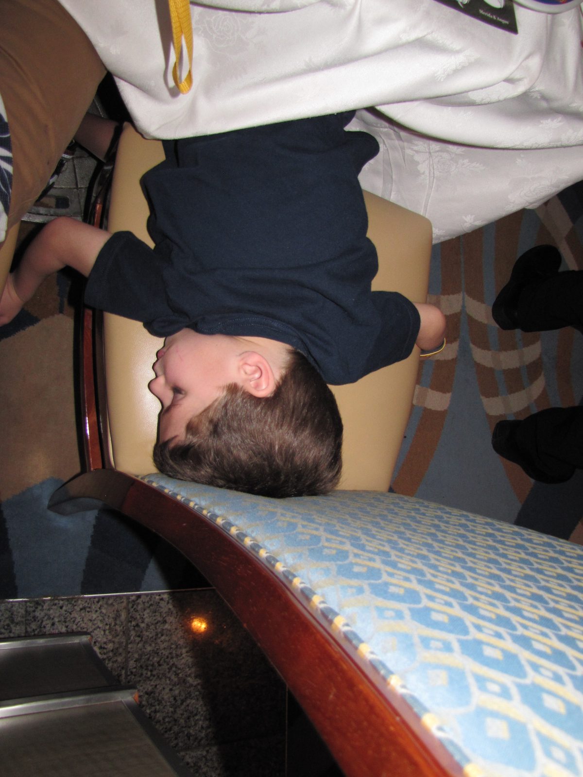 Thomas clowning around upside down on the couch