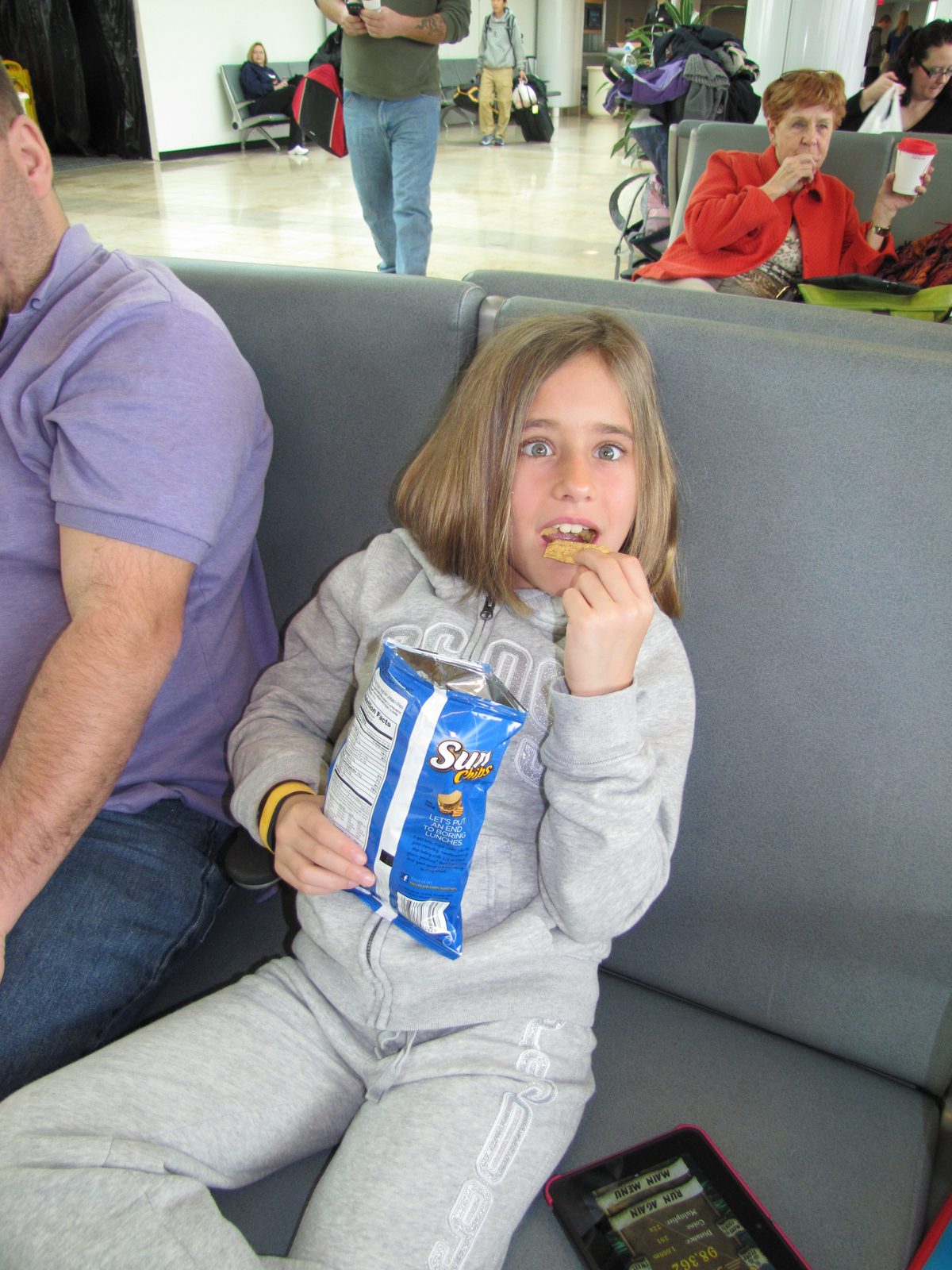 Lisa with a snack at the gate