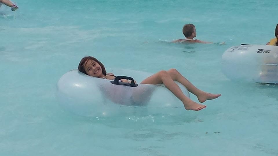 Lisa floating on a tube at Castaway Cay