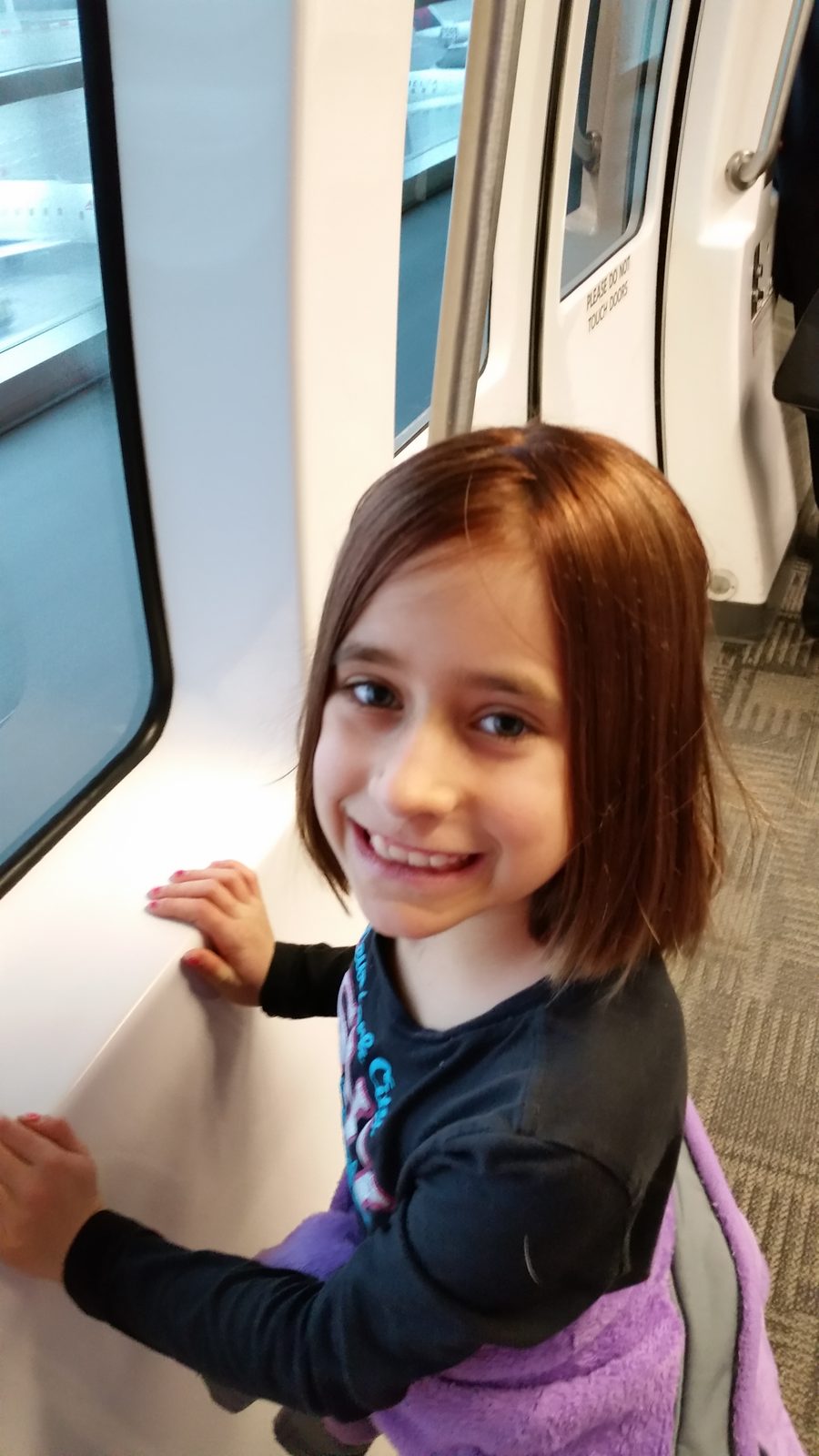 Lisa smiles on the airport train