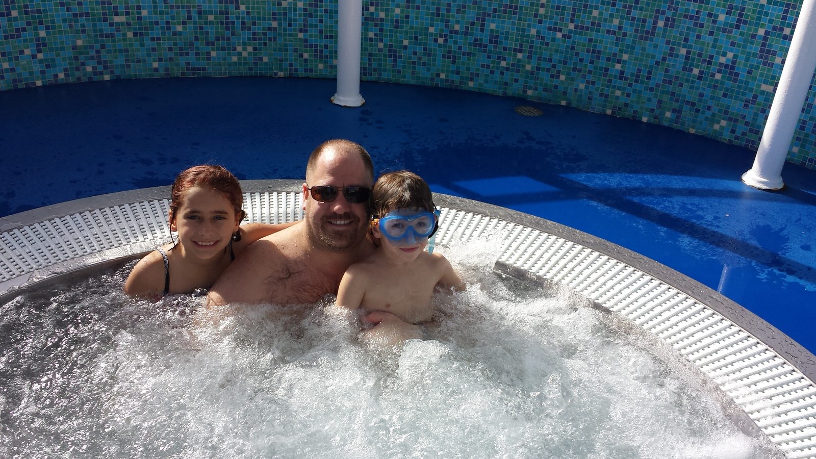 The kids and Michael in the deck hot tub