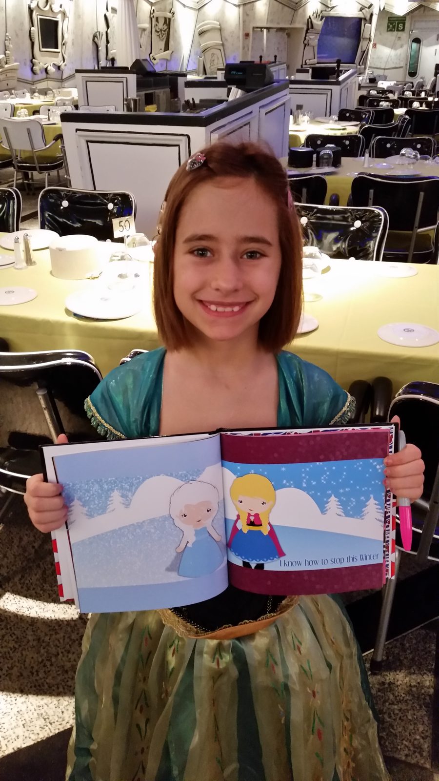 Lisa with her Frozen storybook aboard the Wonder