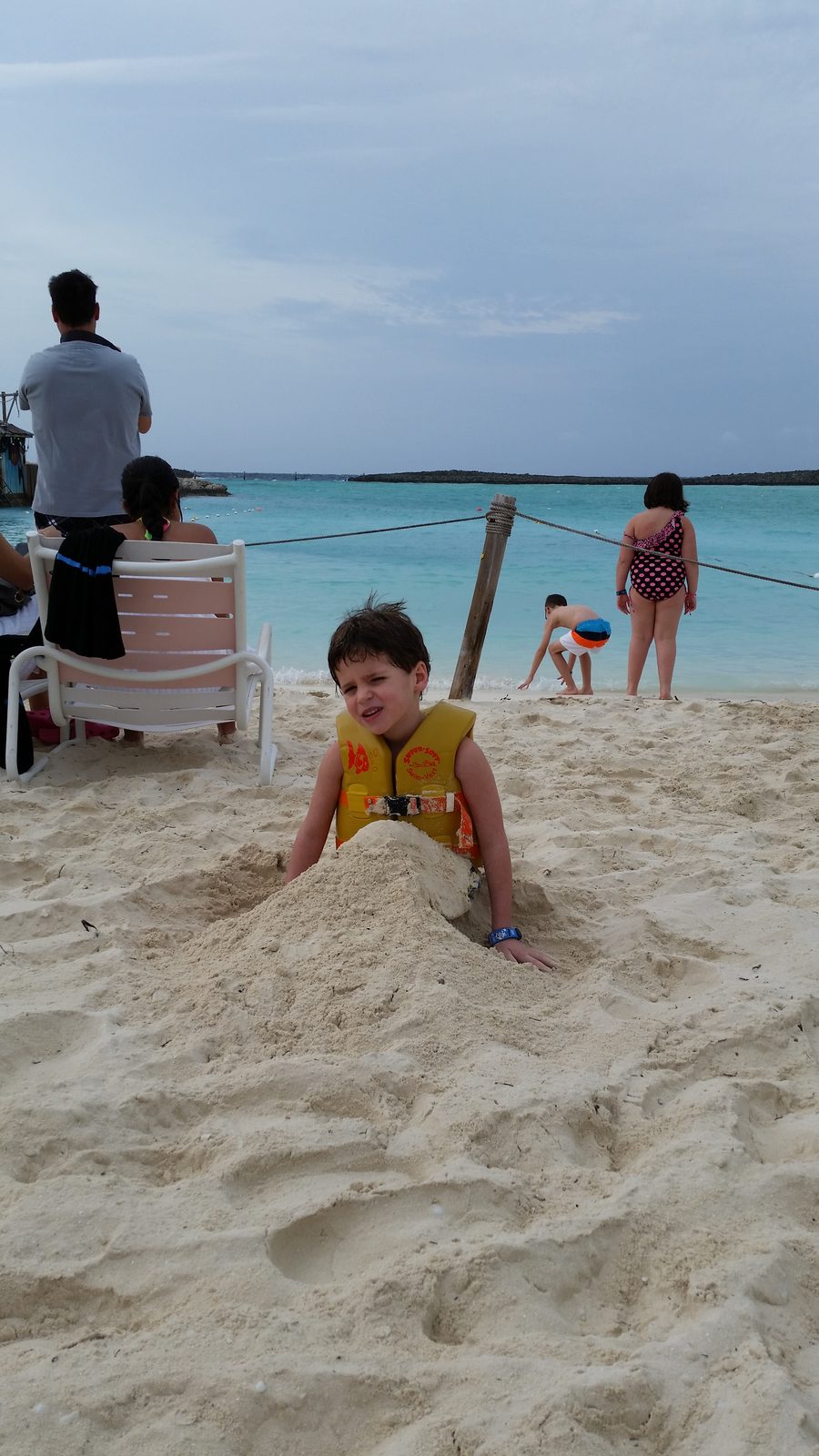 Thomas buried in the sand up to his neck