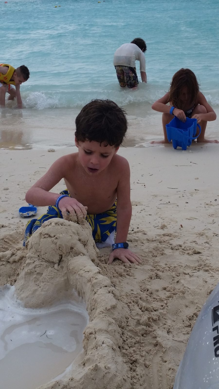 Thomas packing the sand walls at Castaway Cay