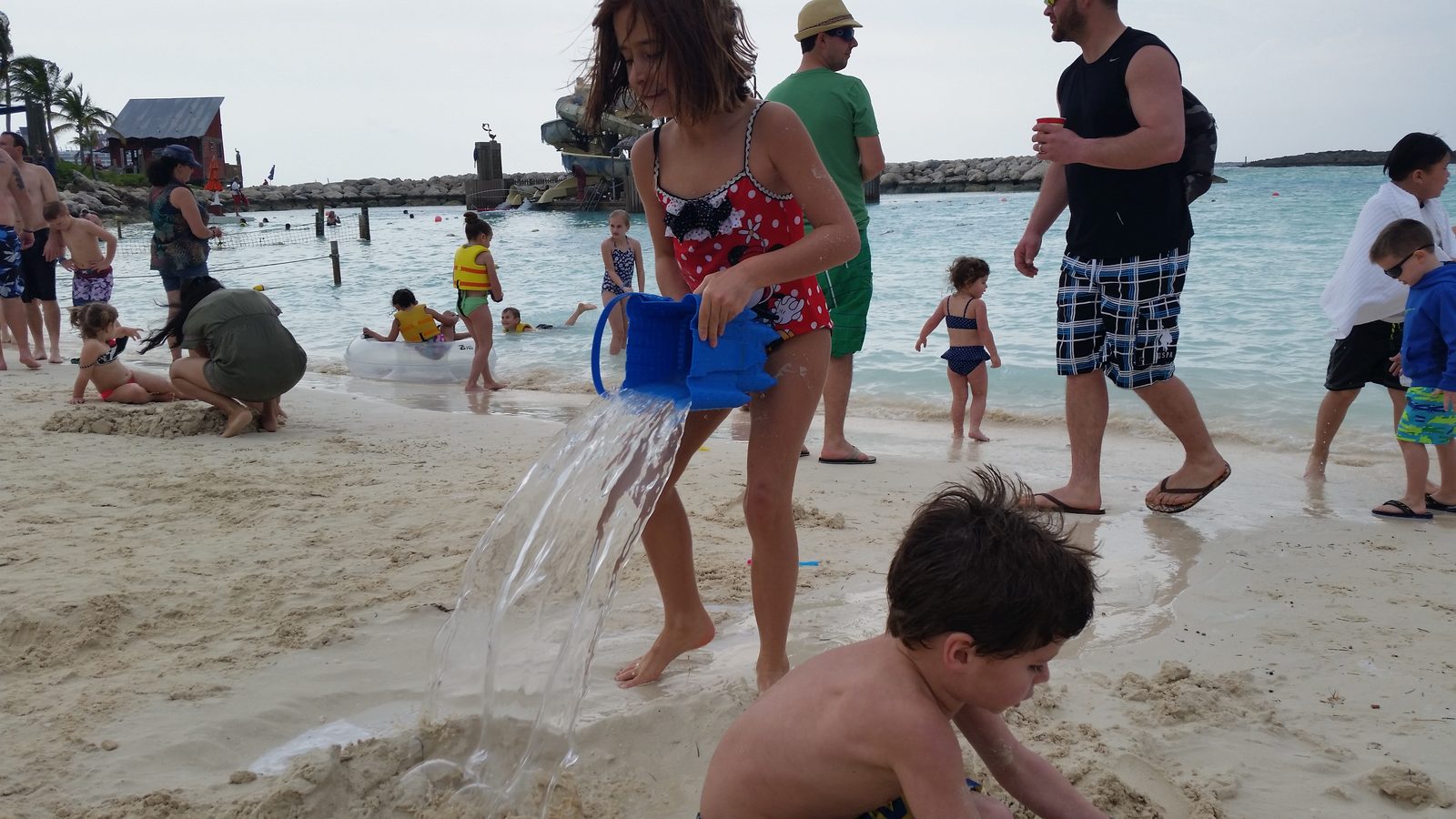 The kids filling the sandcastle moat at Castaway Cay