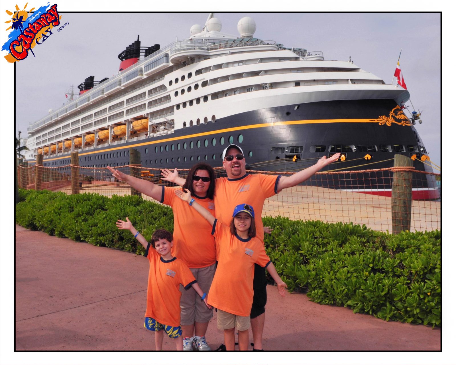 Our family in front of the Wonder, Castaway Cay behind us