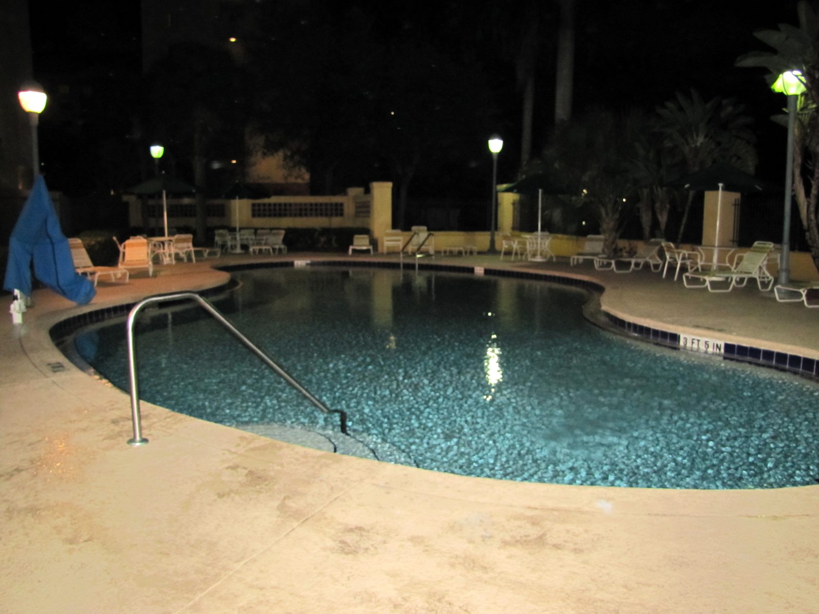 The hotel pool, lit up after dark