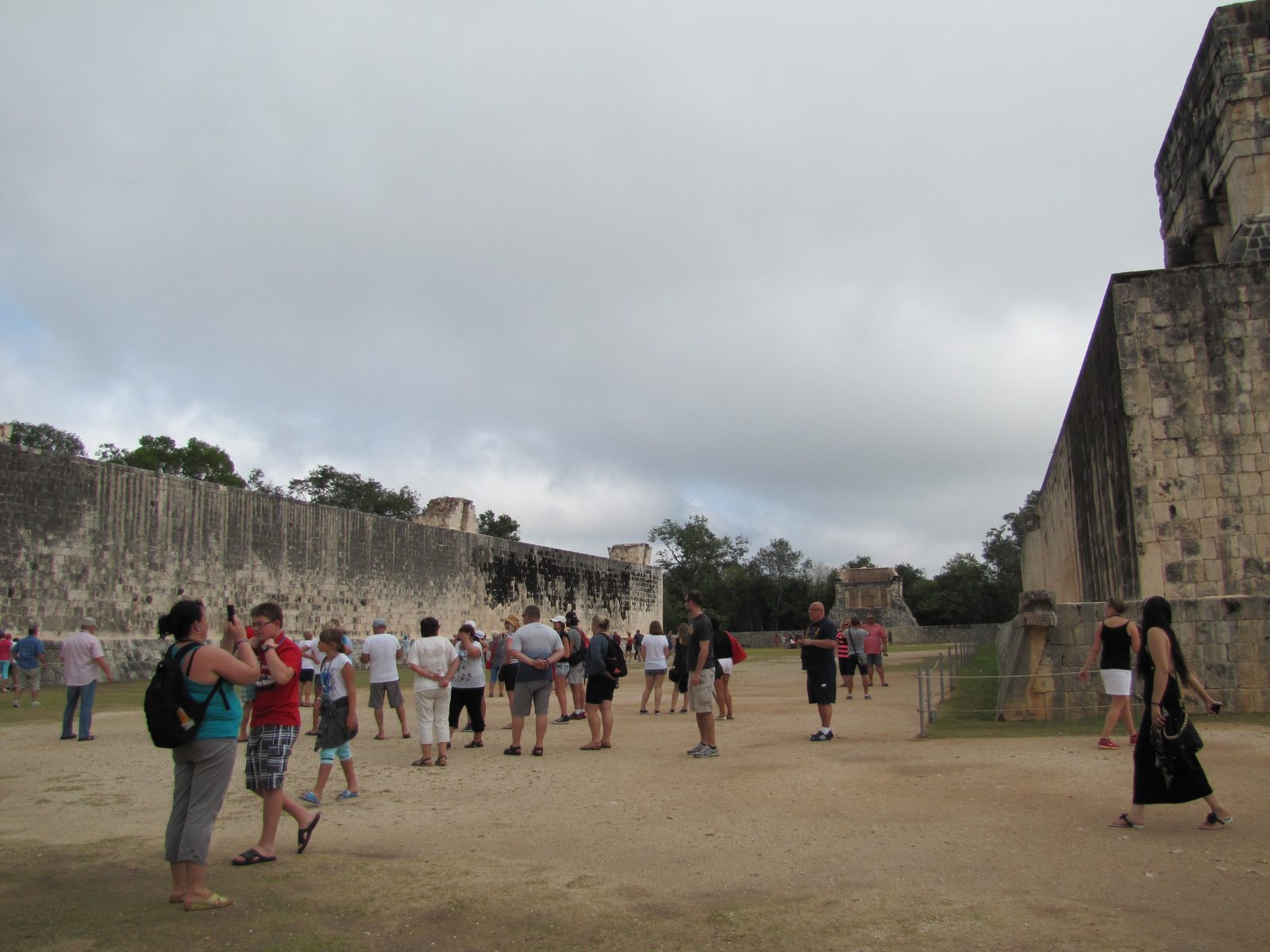 Tourists gather at the Great Ball Court