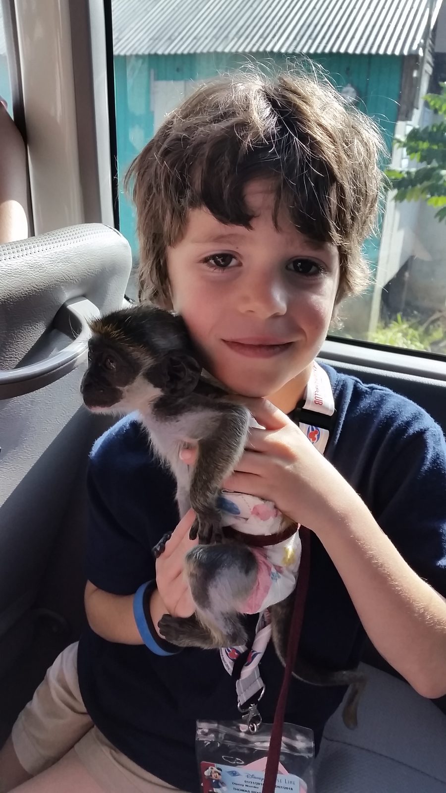 Thomas holding the monkey on the bus in St. Kitts