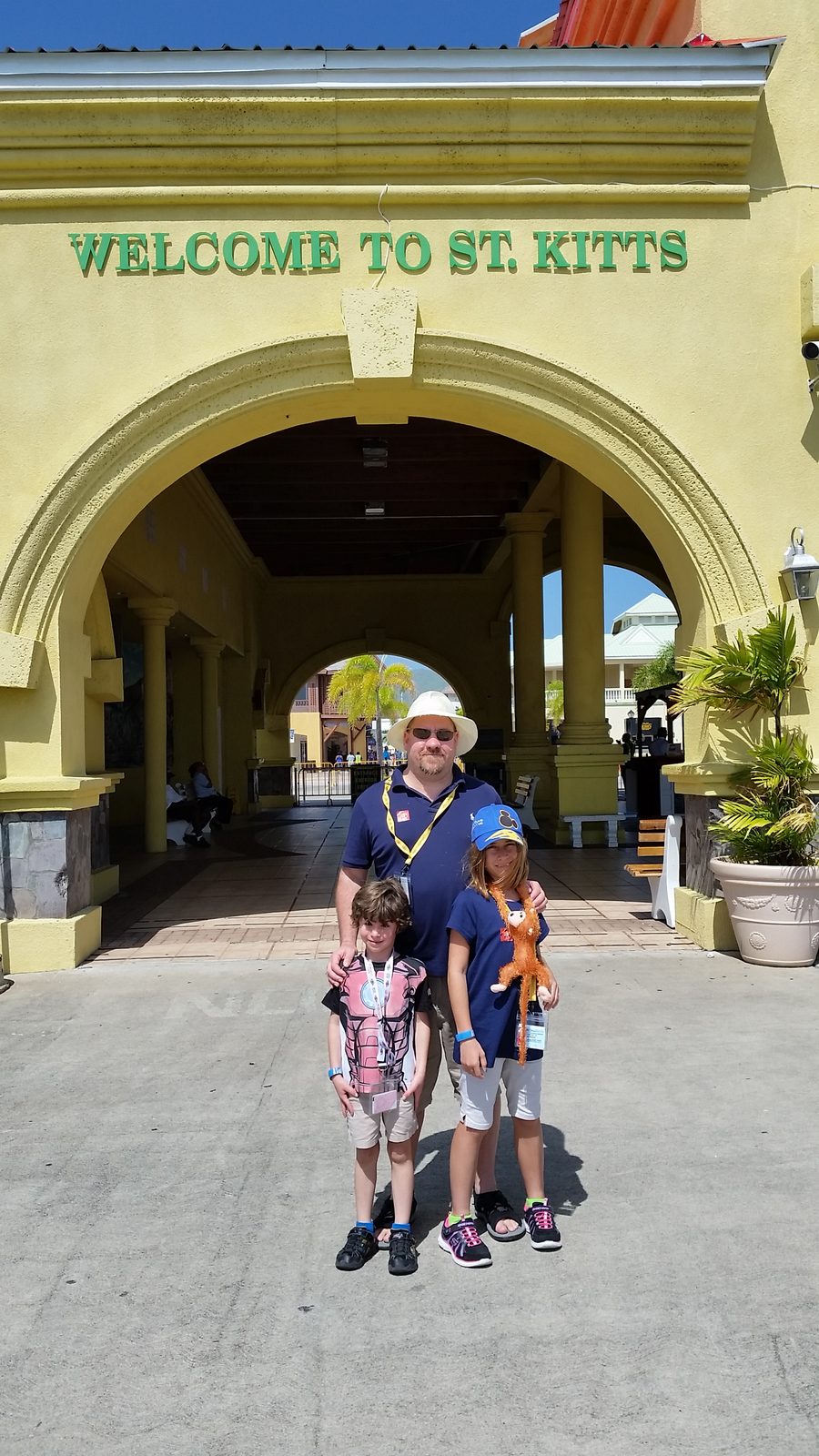 The kids and Michael under the Welcome to St. Kitts arch
