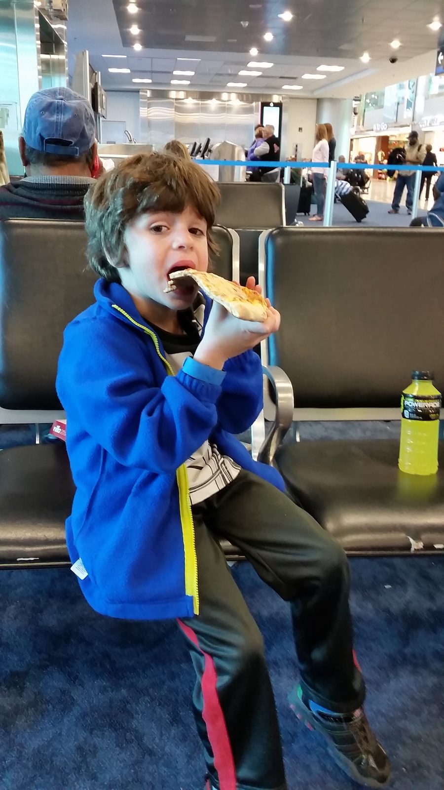 Thomas grabbing pizza at our Miami layover