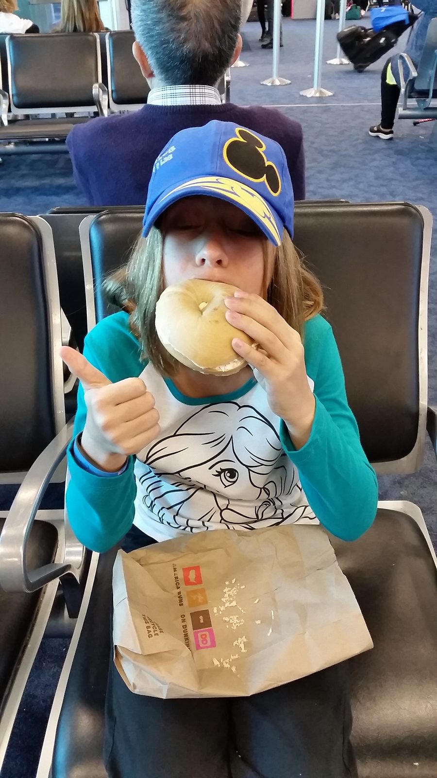 Lisa with a bagel at the Miami airport
