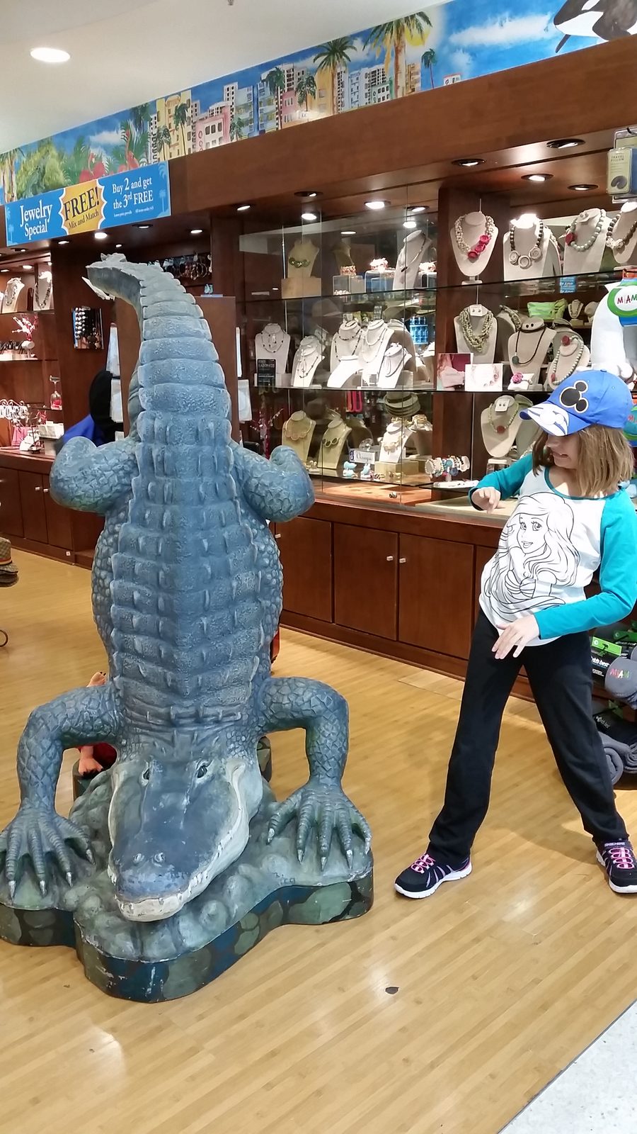 Lisa meets the alligator statue in the Miami airport shop