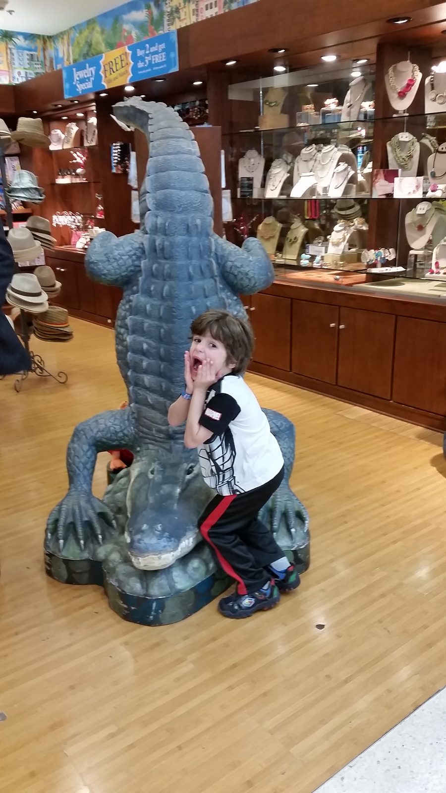 Thomas climbing the alligator statue in Miami