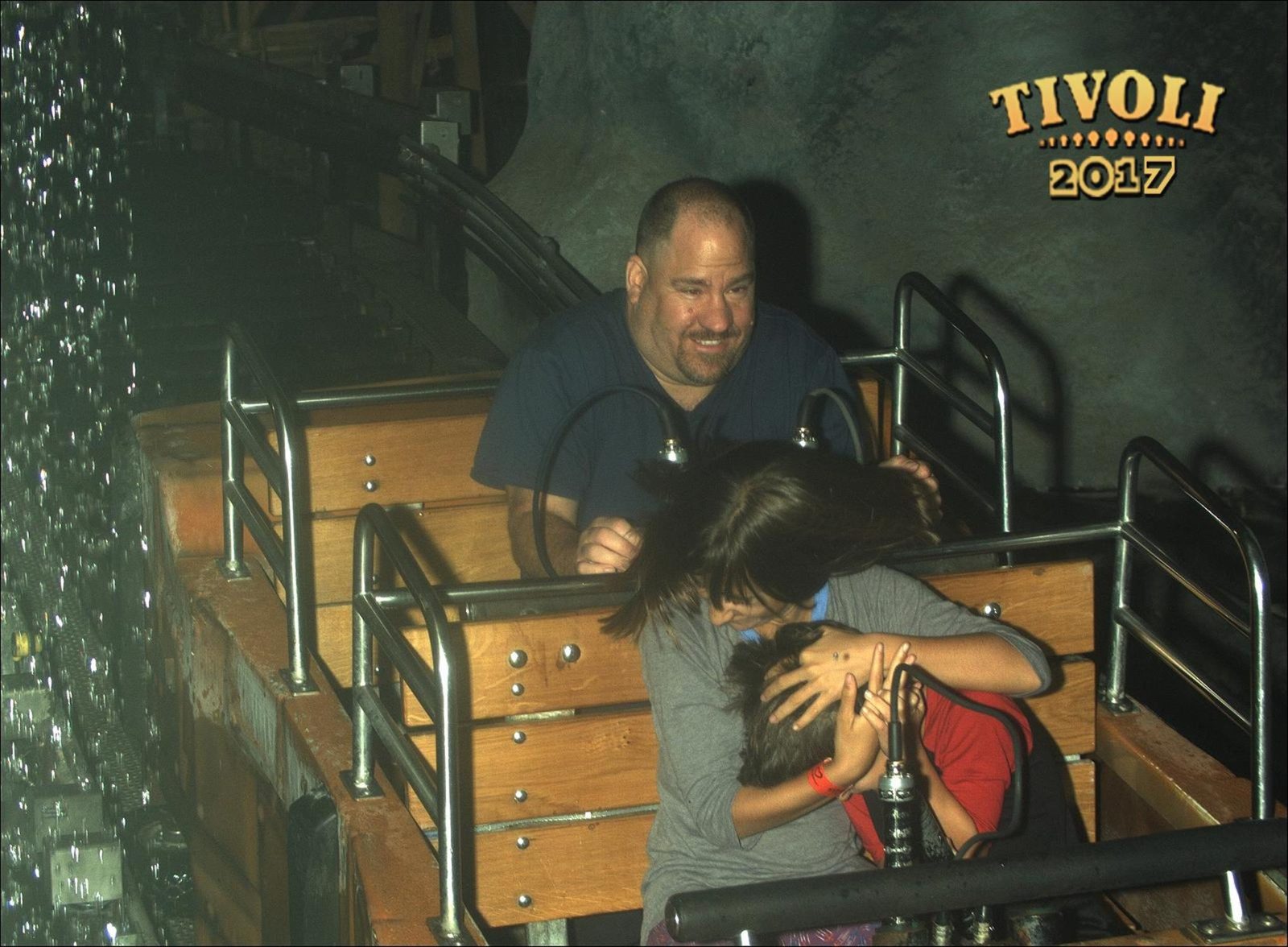 The kids and Michael ducking the waterfall at Tivoli