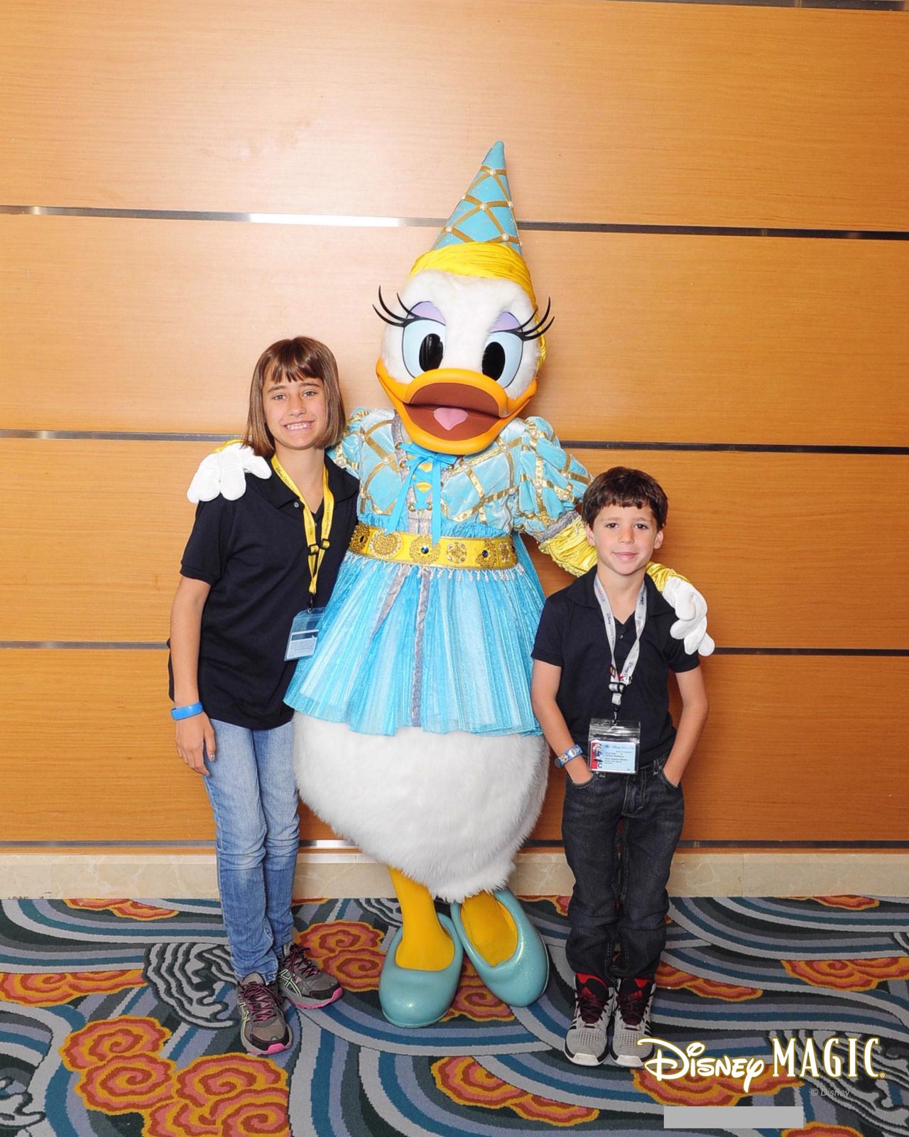 Lisa, Daisy Duck in her blue party dress and party hat, and Thomas