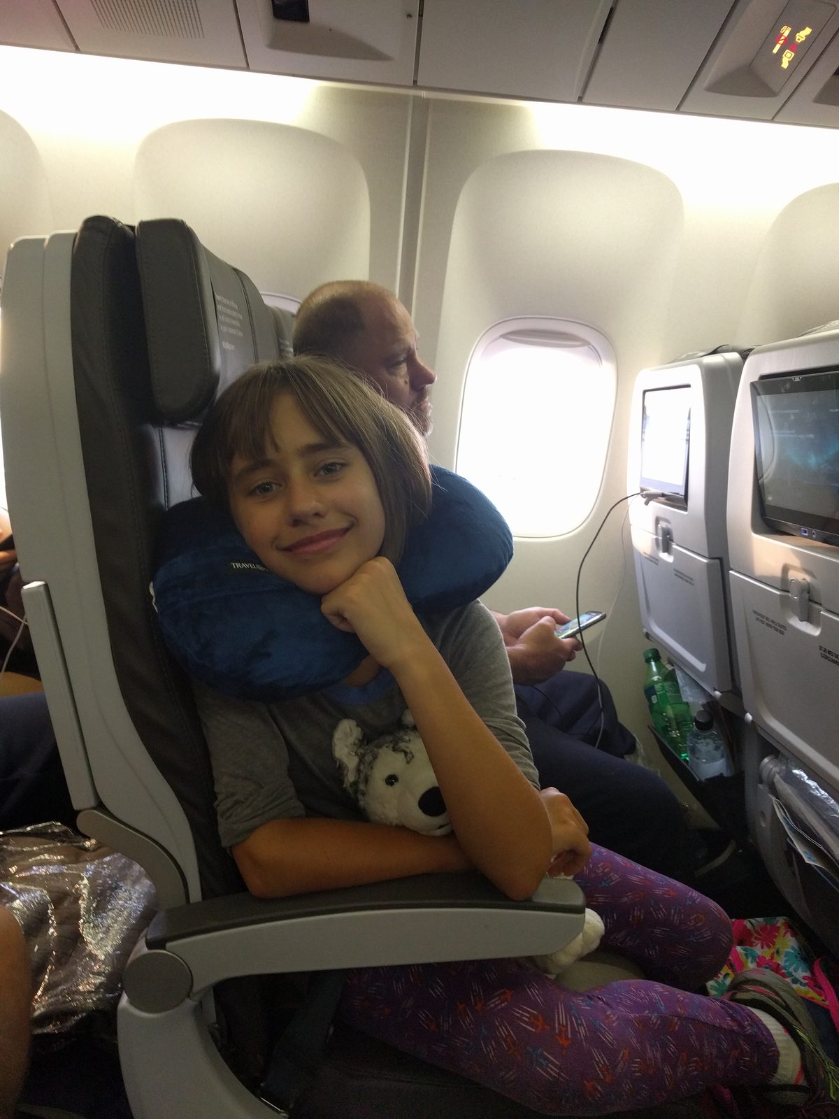Lisa settles in early with her stuffed animal, ready to sleep