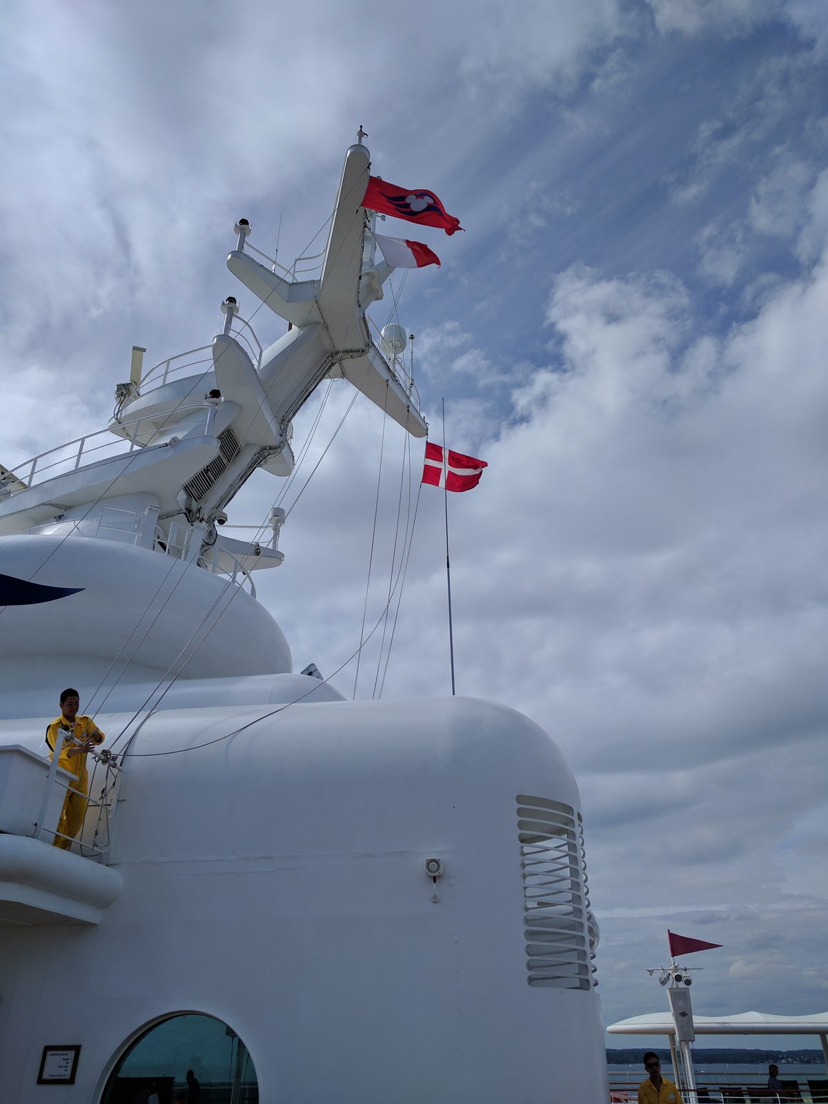Flags flying above the ship, still tied up in port