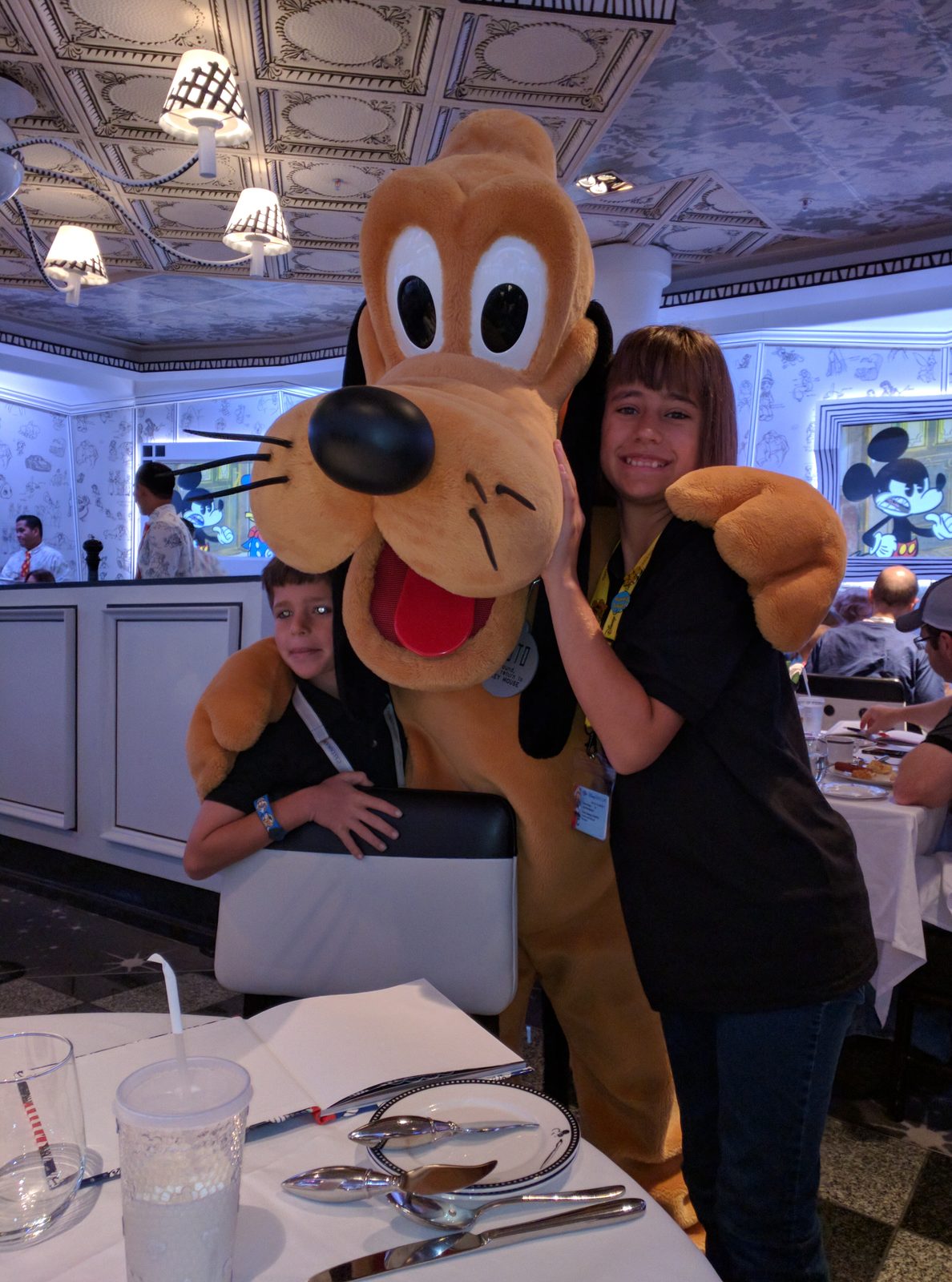 Pluto and Lisa hugging at character breakfast
