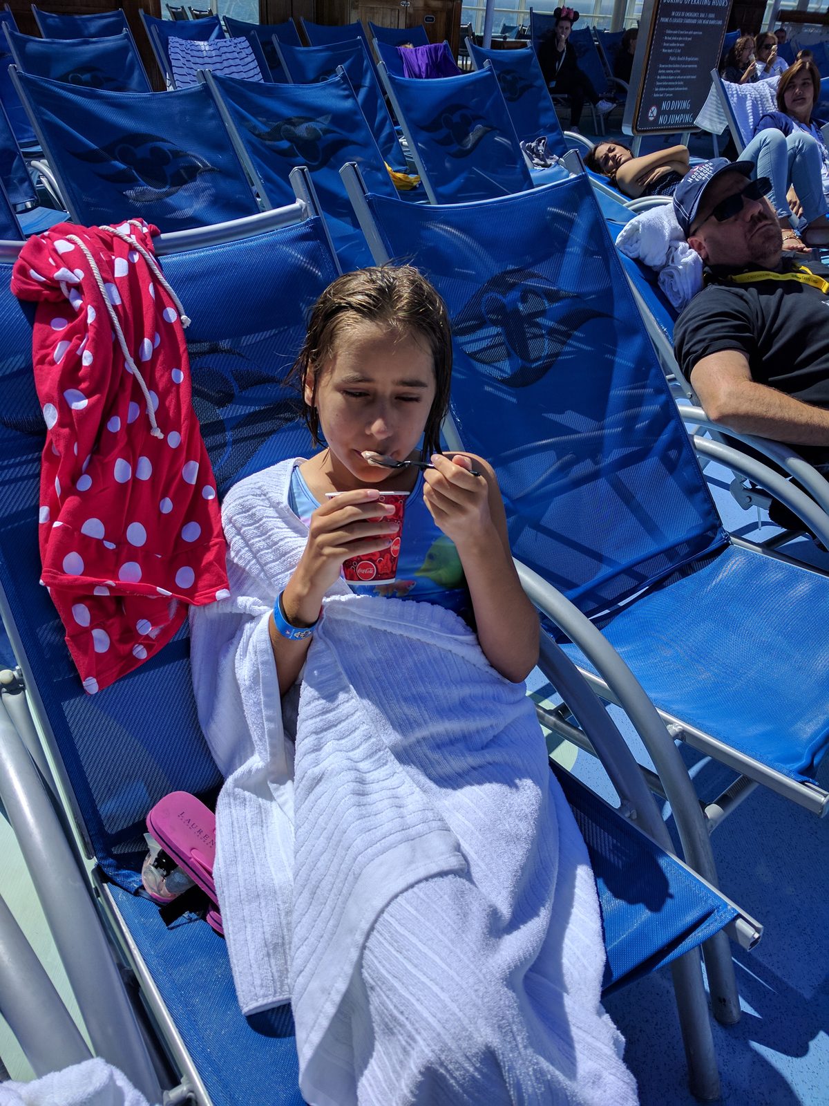 Lisa wrapped in towels by the pool on the Magic