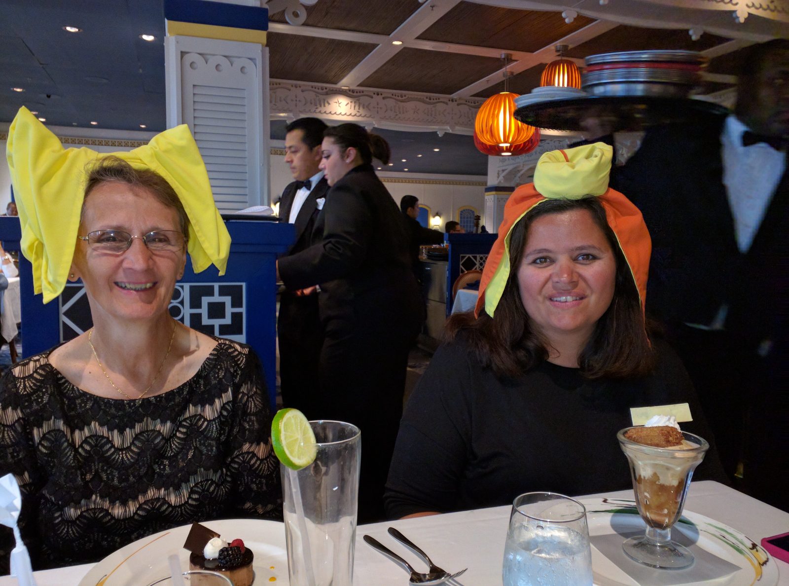 Grandma and Kathy in napkin hats at dinner on formal night