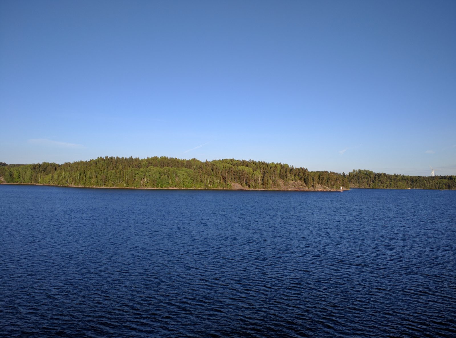 Blue water and a wooded island as we sail out