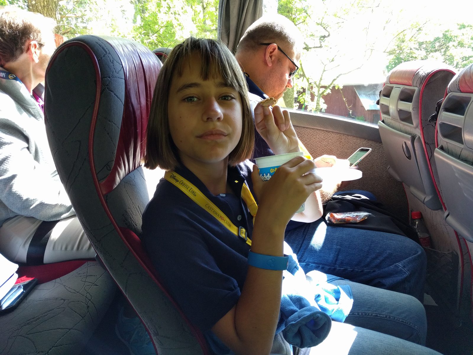 Lisa eating yogurt on the bus