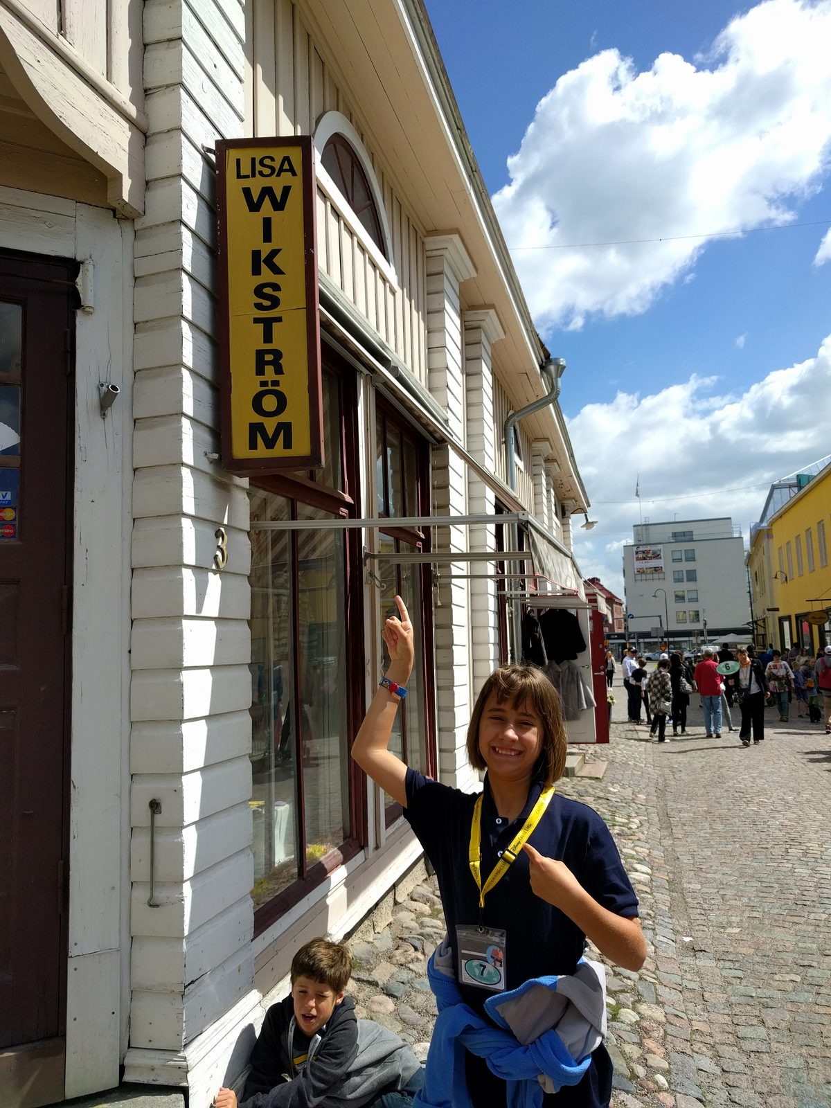 Kathy poses by a shop sign that shares Lisa's name