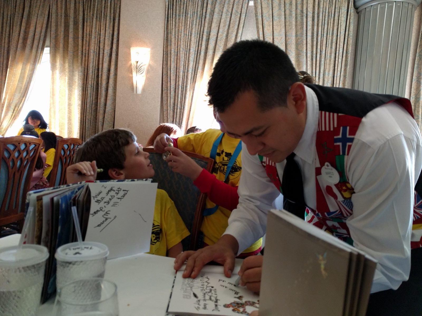 Marco, our server, signs Thomas's autograph book