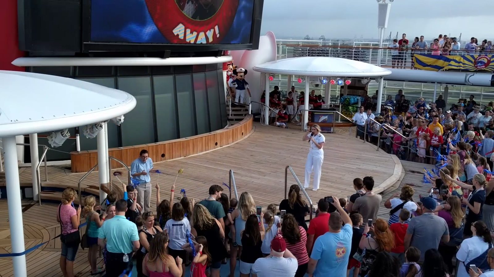 An ASL interpreter signing the Adventures Away deck party while Natalie introduces the Characters