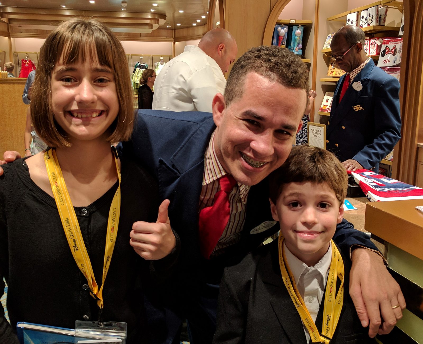 Lisa and Thomas pose with a ship's officer in the shop