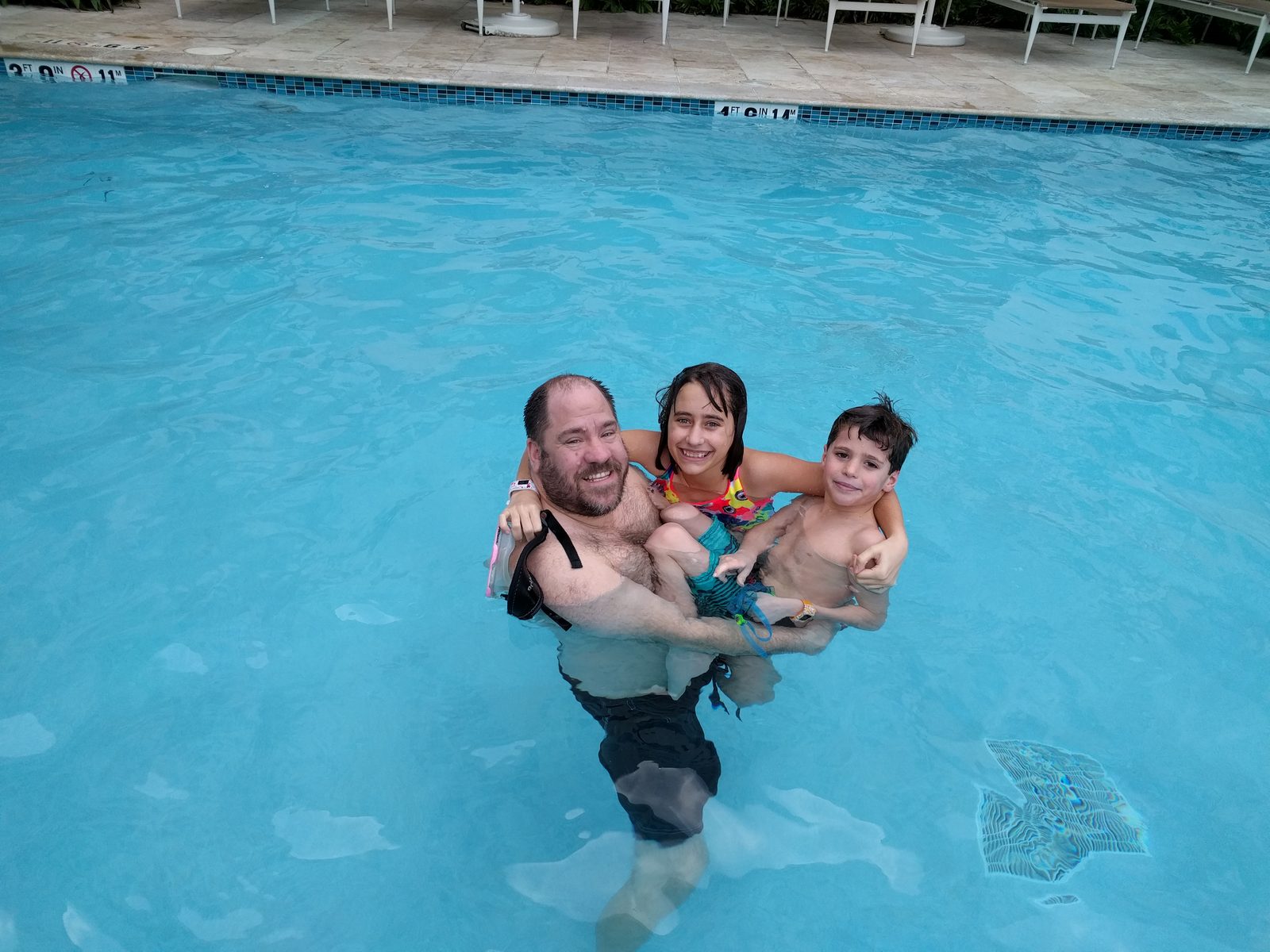 Carrying Lisa and Thomas around the hotel pool