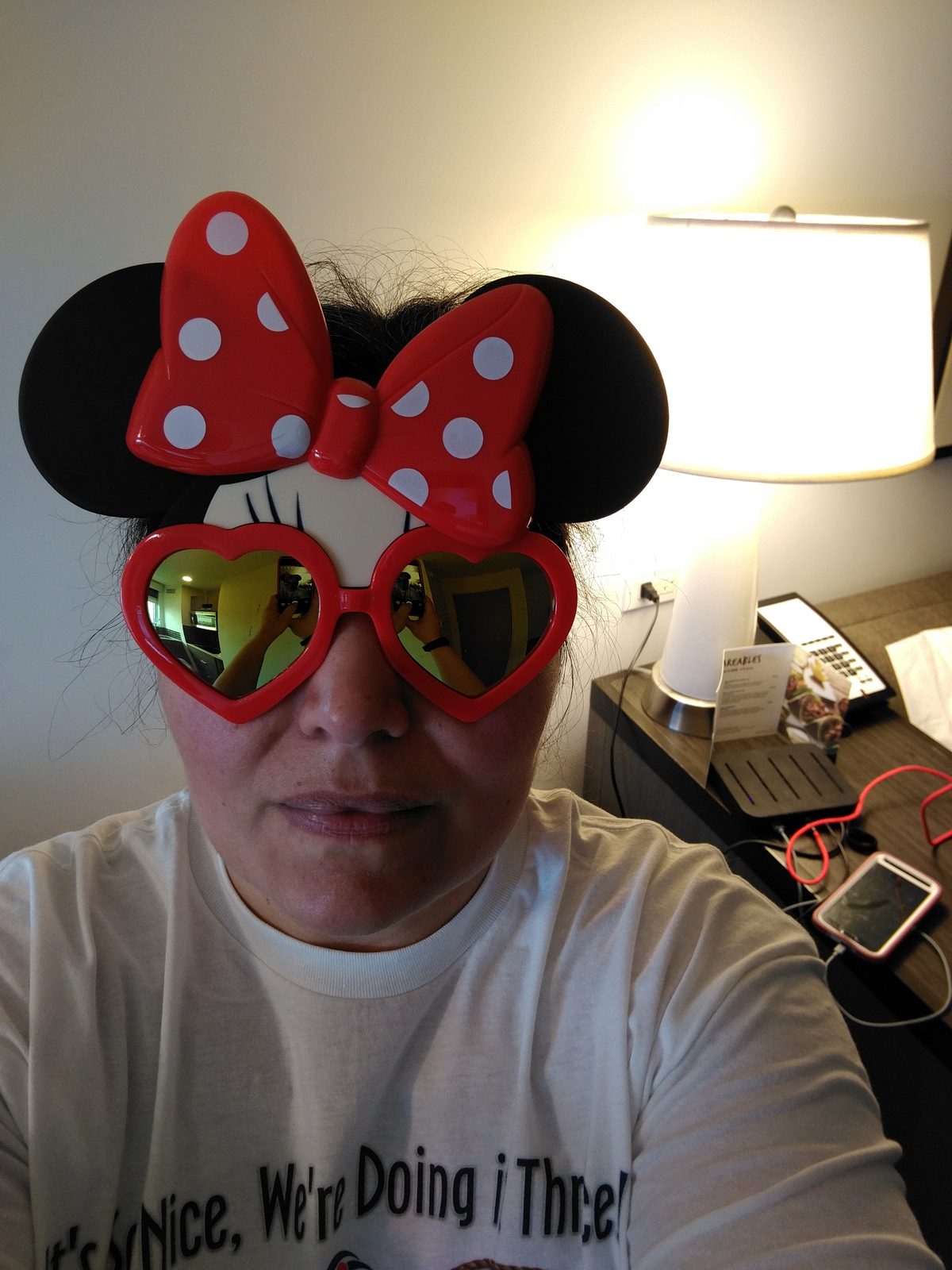Kathy ready to board, Minnie ears and heart glasses