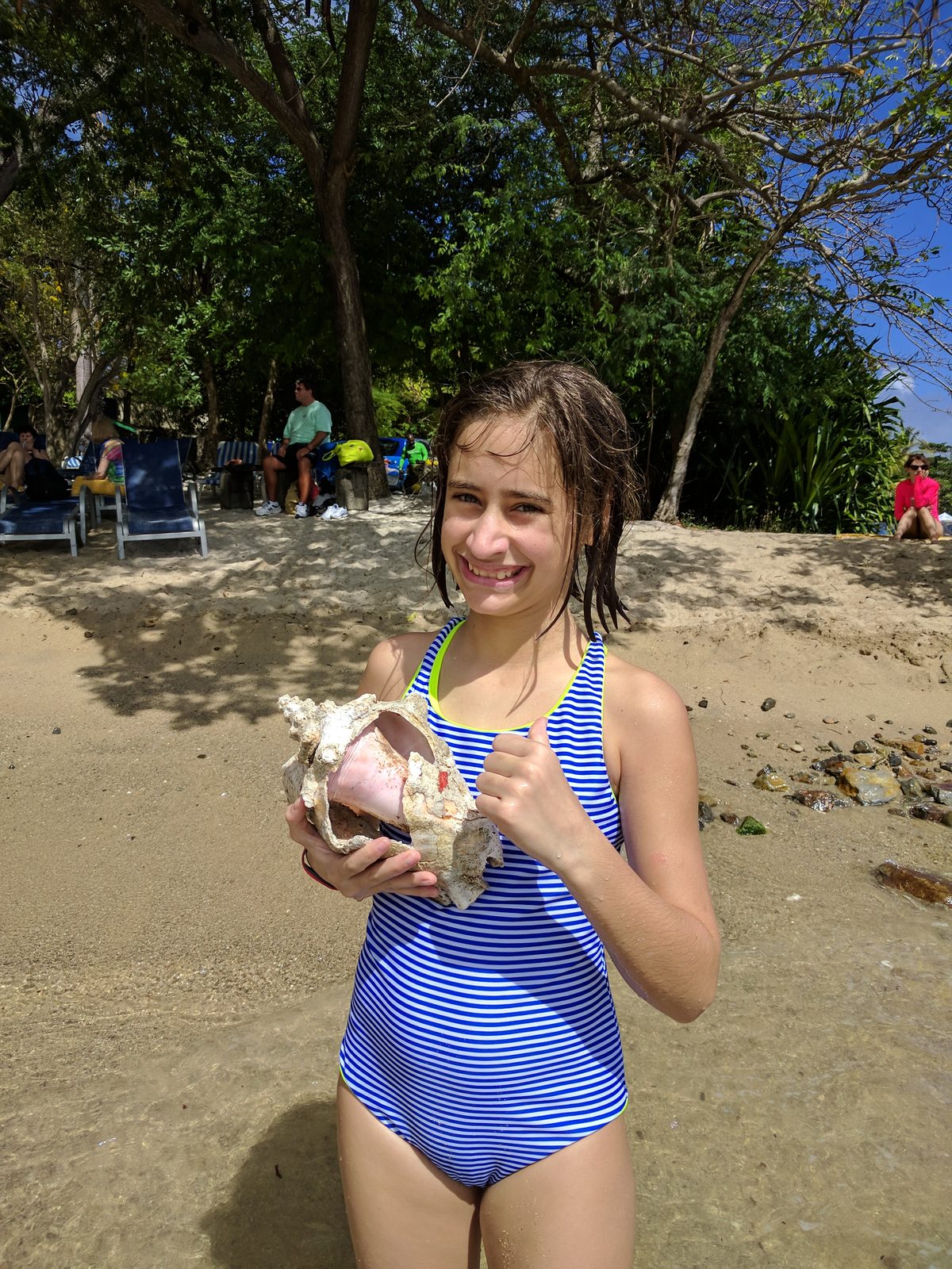 Lisa dripping wet, still holding her shell