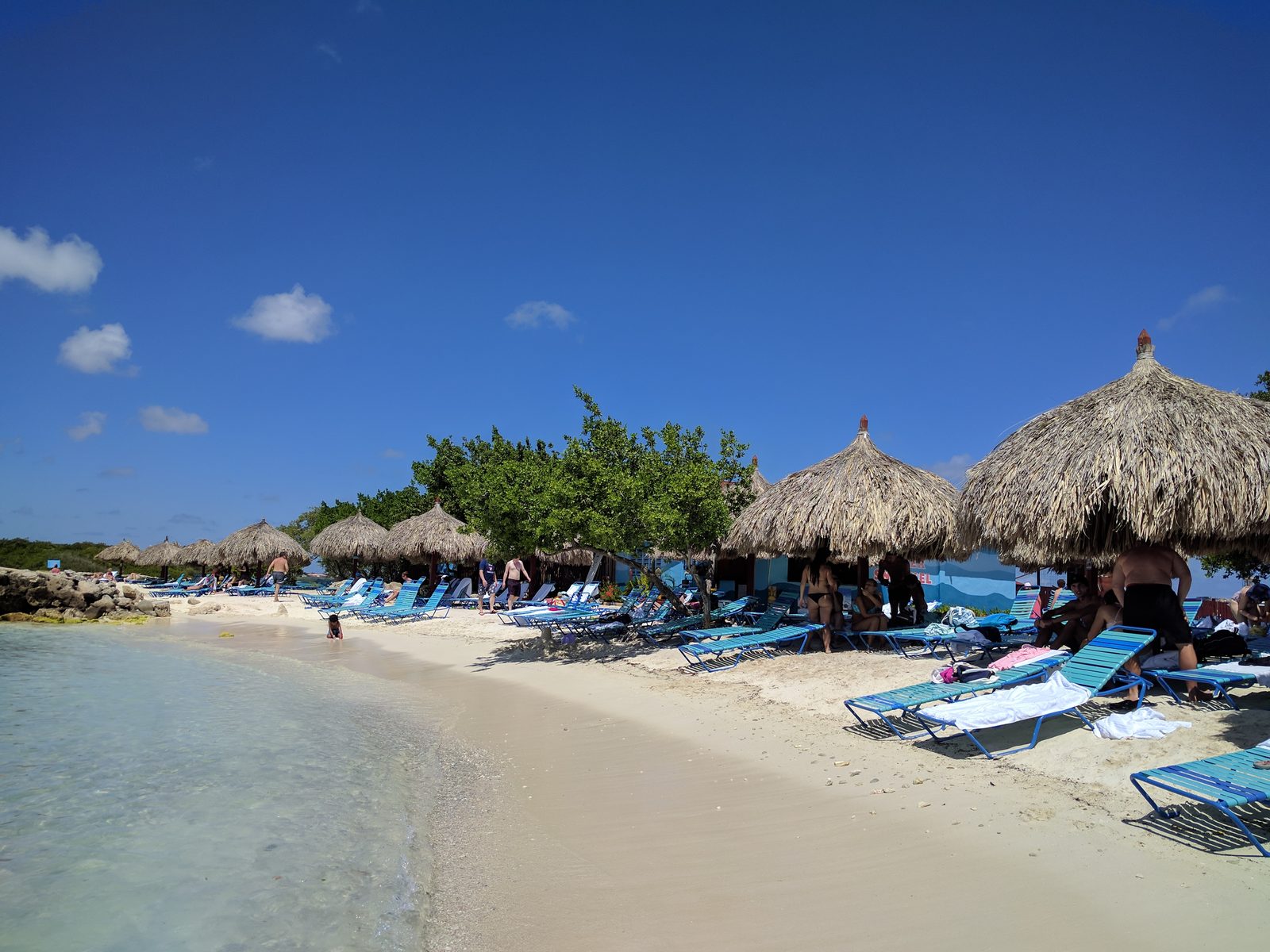 Palapas along the beach at De Palm Island