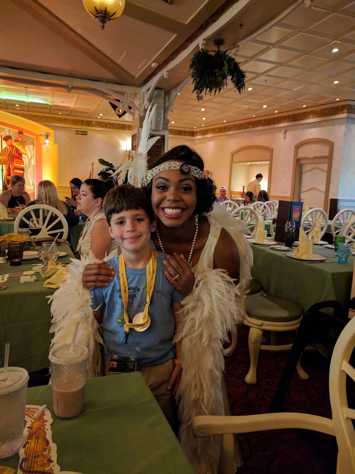 Thomas with Tiana in her 1920s flapper-style gown at dinner in Tiana's Place