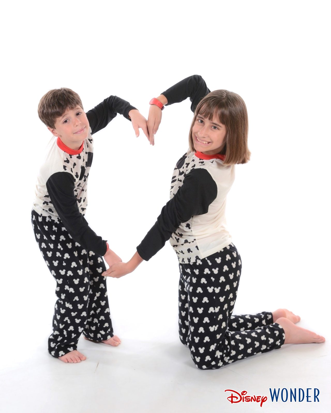 The kids making a heart in Mickey pajamas