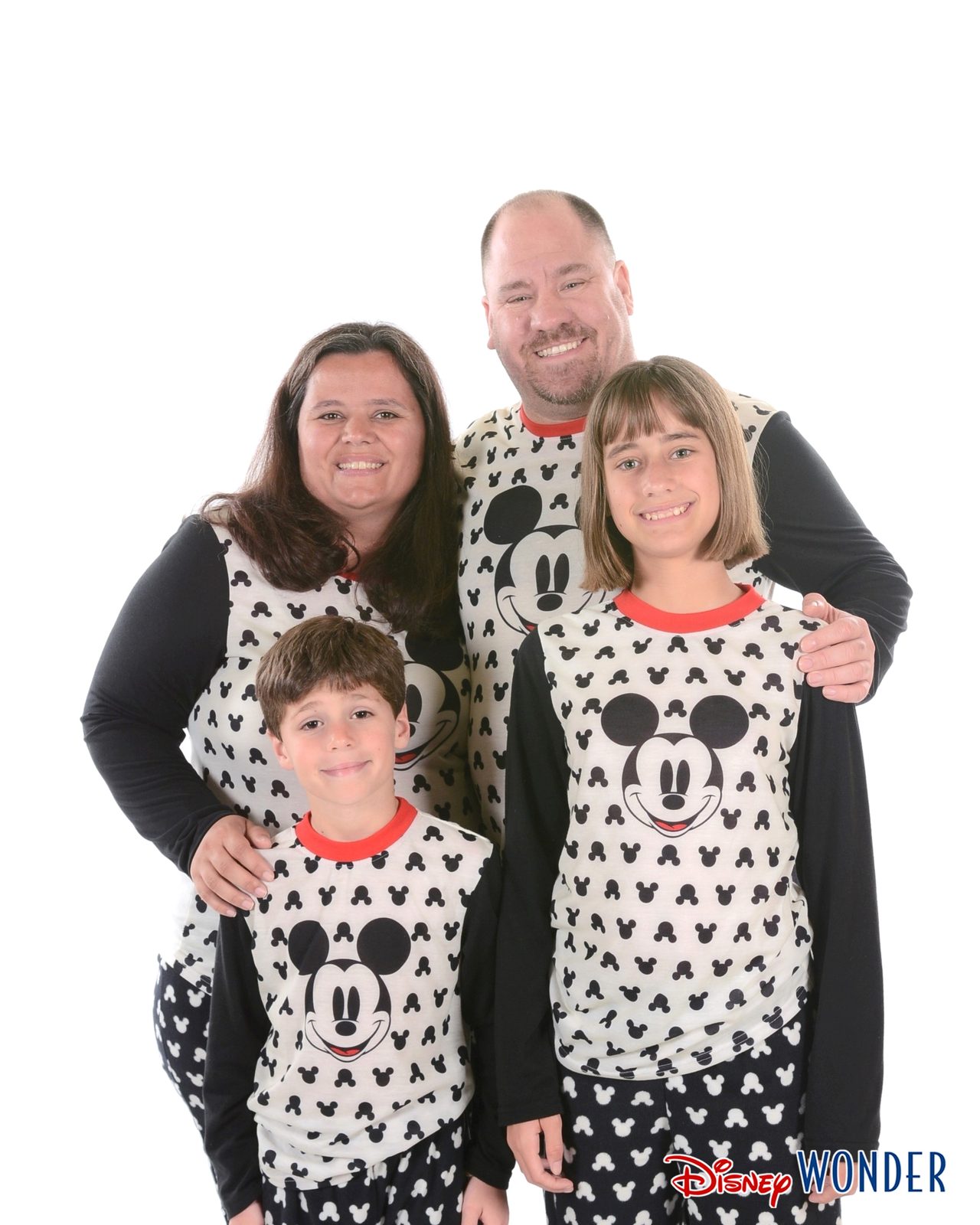 The four of us standing in Mickey pajamas on the Wonder
