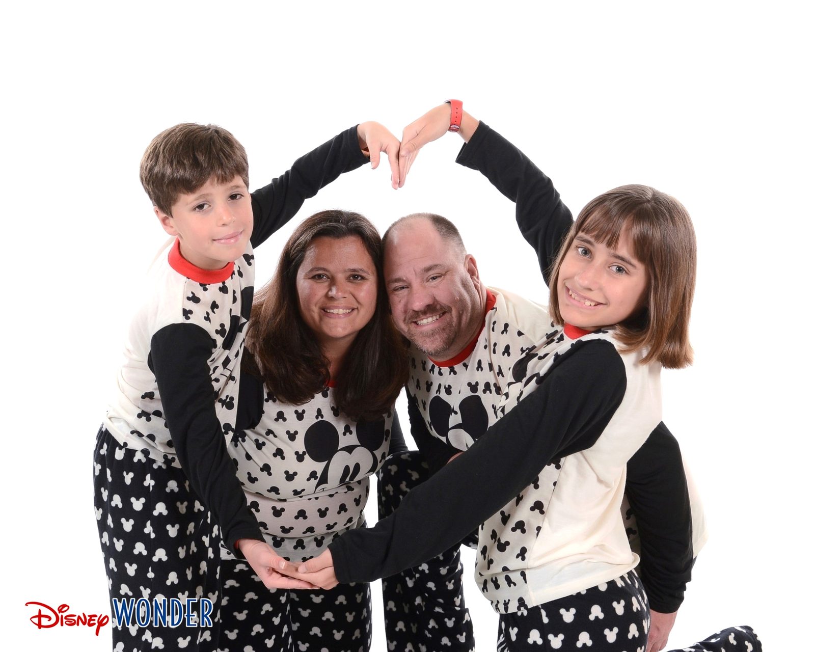 The four of us making a heart in Mickey pajamas