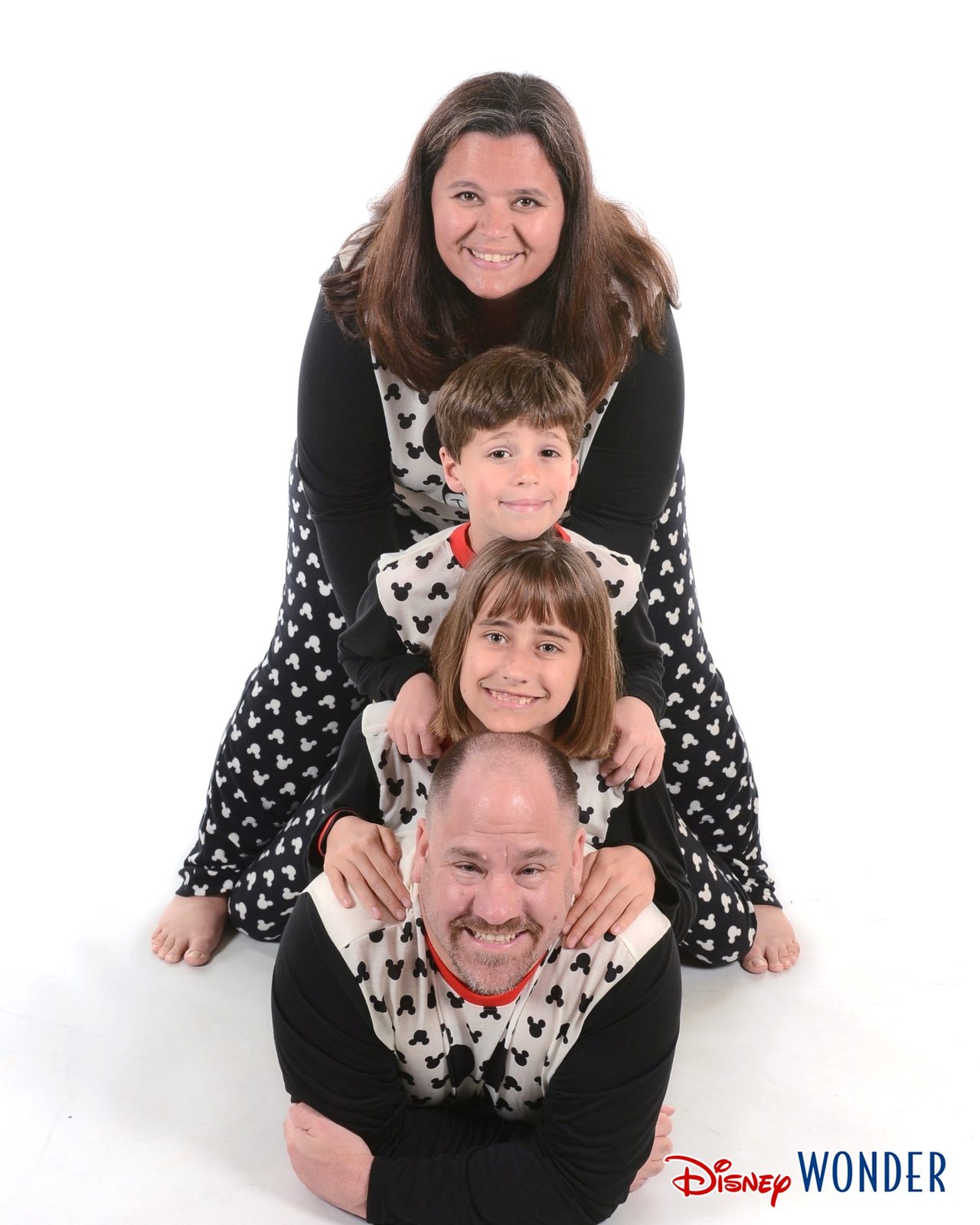 The four of us stacked up in Mickey pajamas on the Wonder