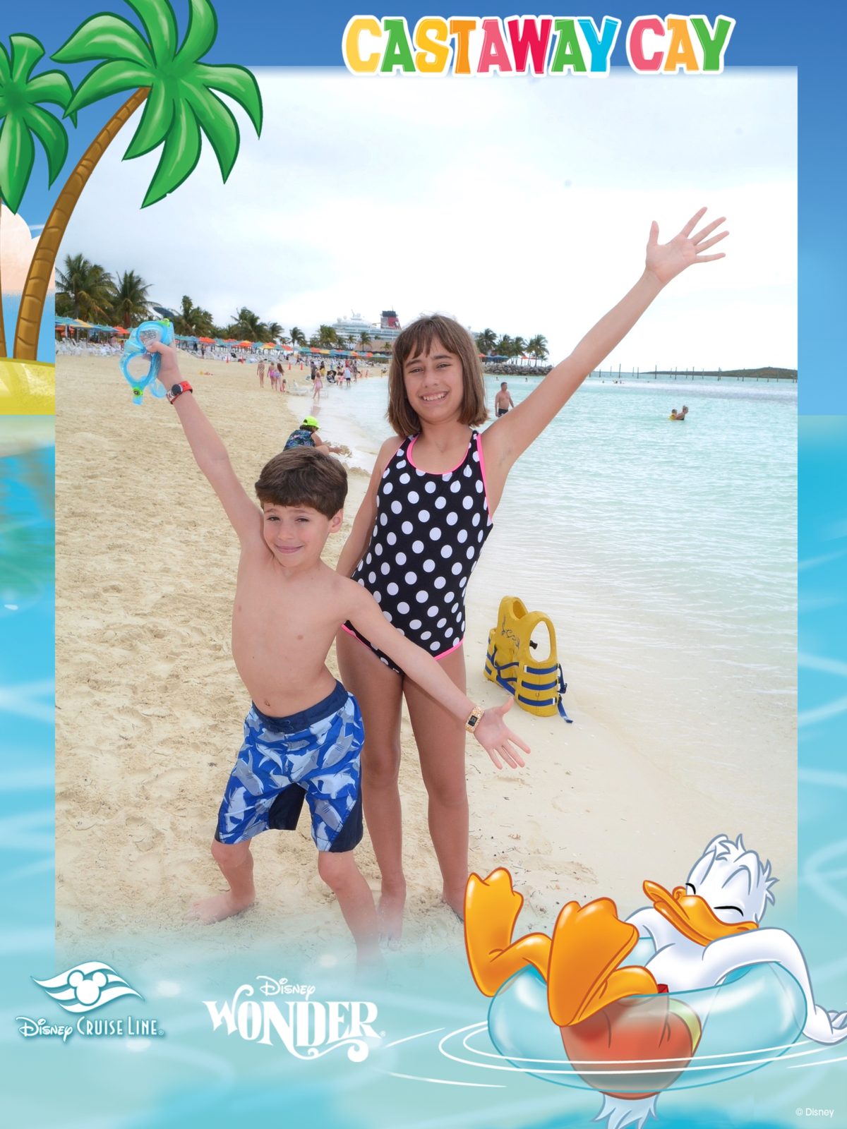 Thomas and Lisa with arms up on the beach at Castaway Cay