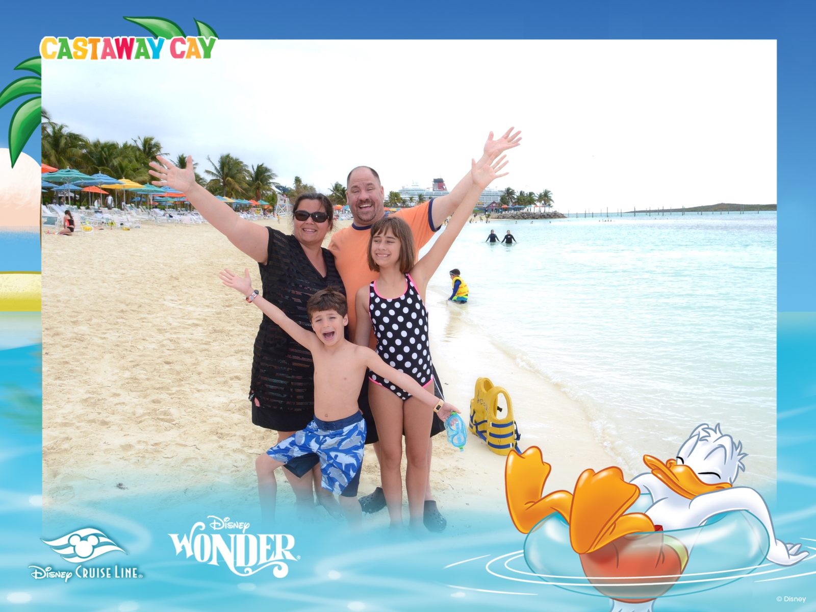 The four of us with arms up at Castaway Cay