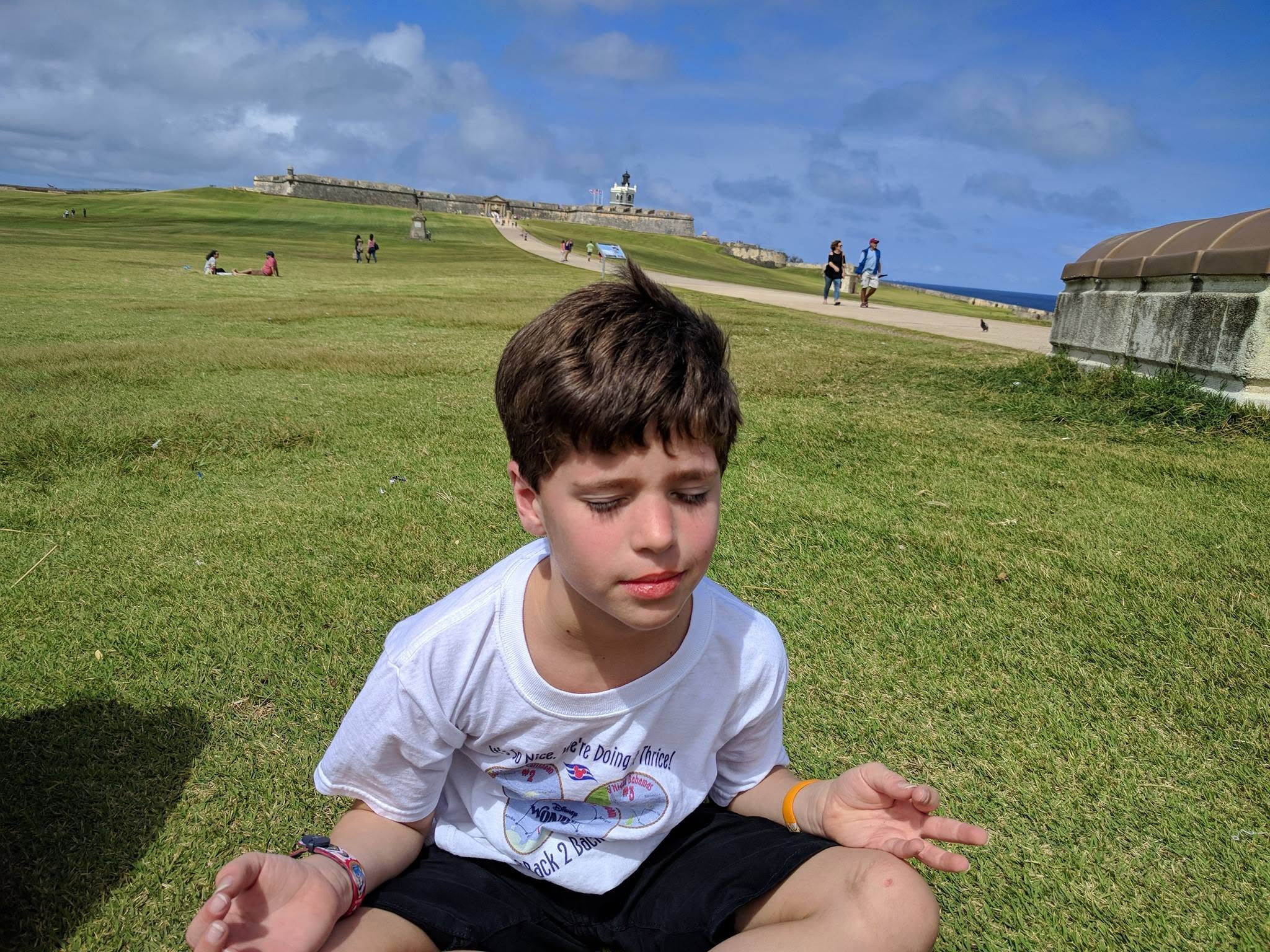 Cross-legged on the lawn by the fort in San Juan