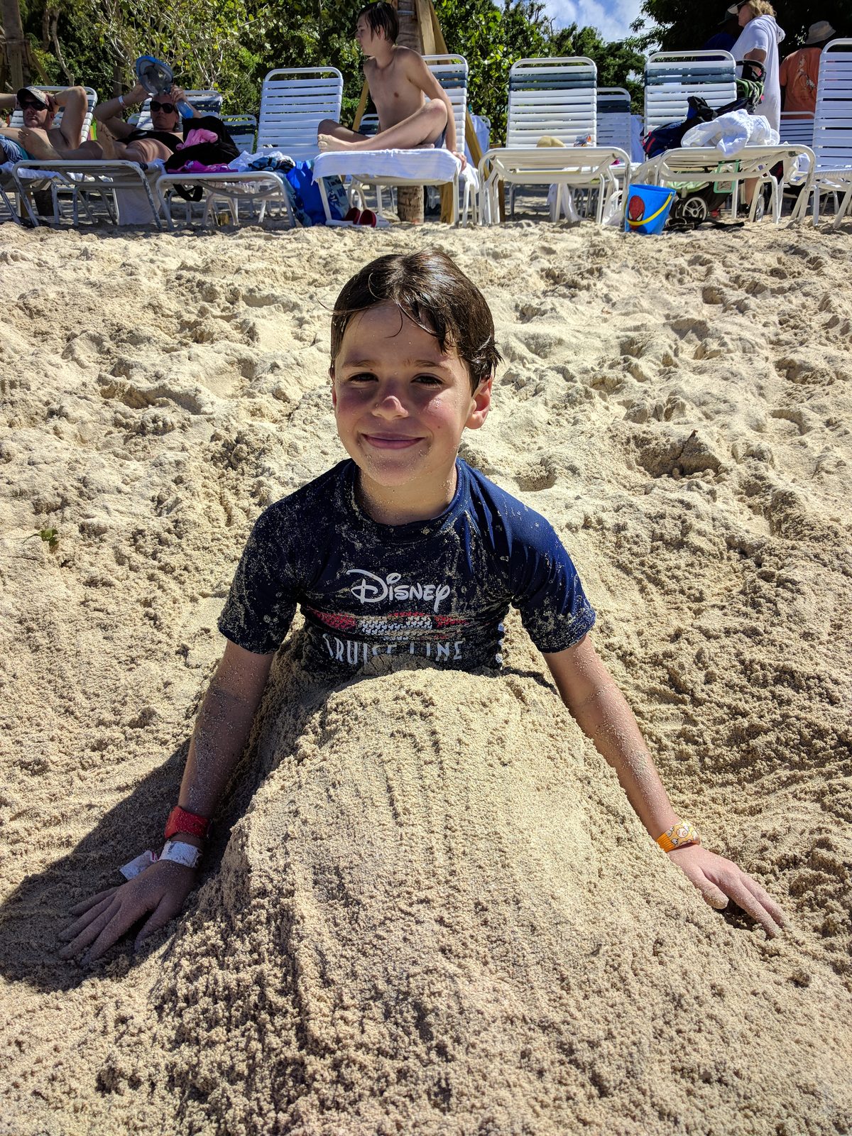 Thomas buried in the sand at Magens Bay
