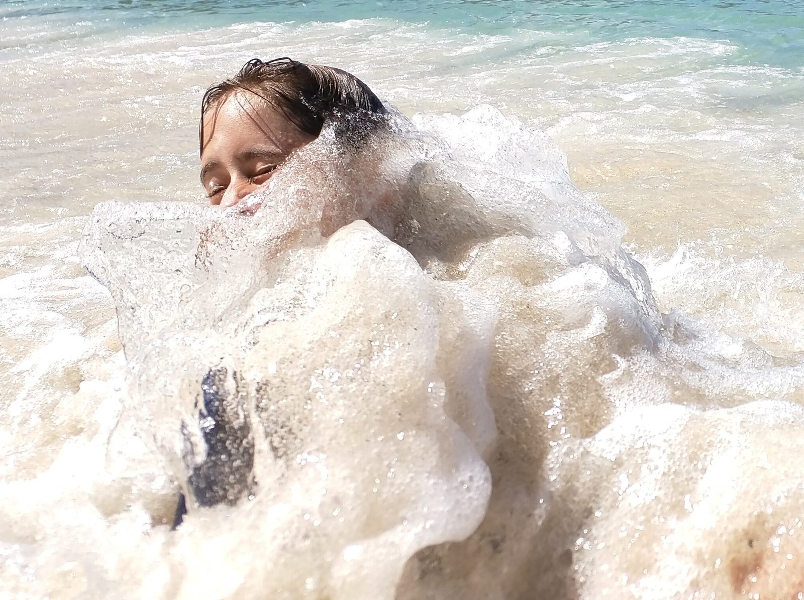 Lisa caught in a wave
