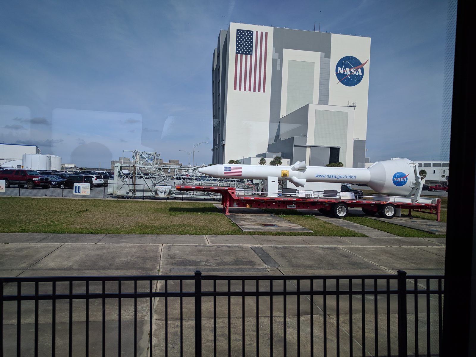 Passing the Vehicle Assembly Building with a rocket in tow