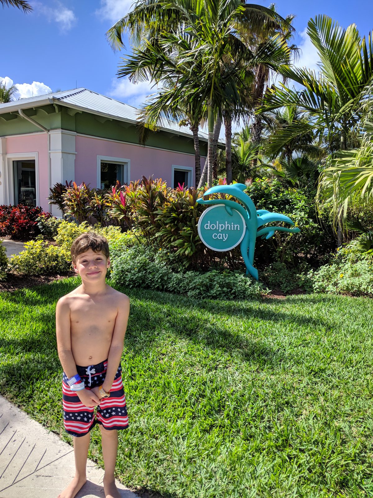 Thomas at the Dolphin Cay sign
