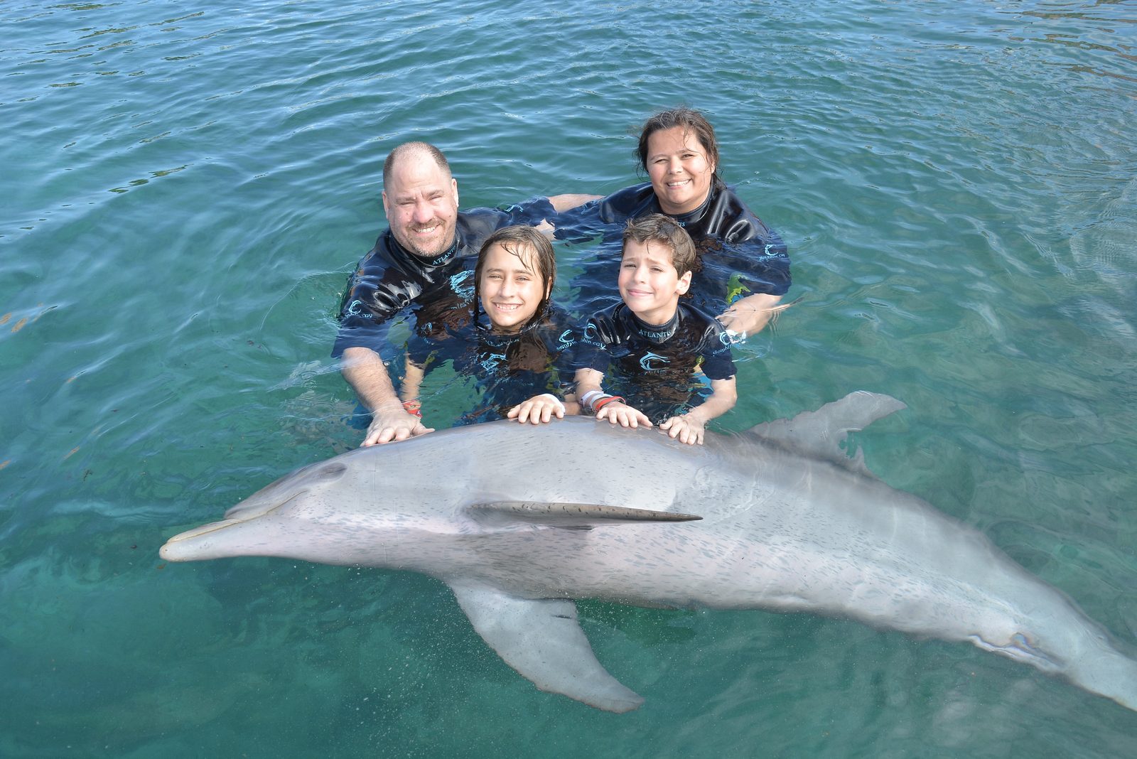 The whole family with their dolphin